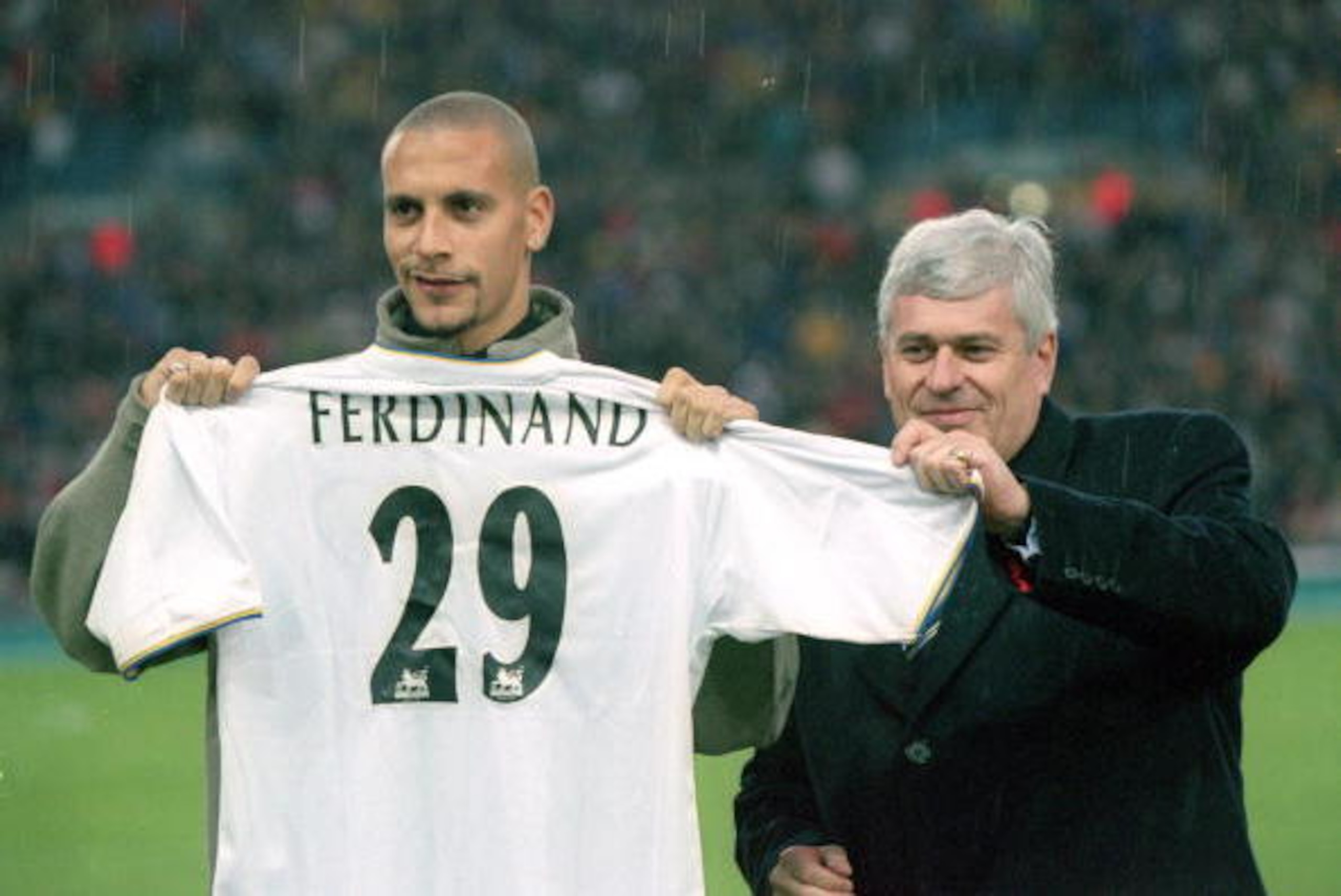 26 Nov 2000: Leeds United record signing Rio Ferdinand receives his new shirt from Leeds United chairman Peter Risdale before the FA Carling Premiership match played at Elland Road, in Leeds, England. Leeds United won the match 1-0. \ Mandatory Credit: C 26 Nov 2000: Leeds United record signing Rio Ferdinand receives his new shirt from Leeds United chairman Peter Risdale before the FA Carling Premiership match played at Elland Road, in Leeds, England. Leeds United won the match 1-0. \ Mandatory Credit: C