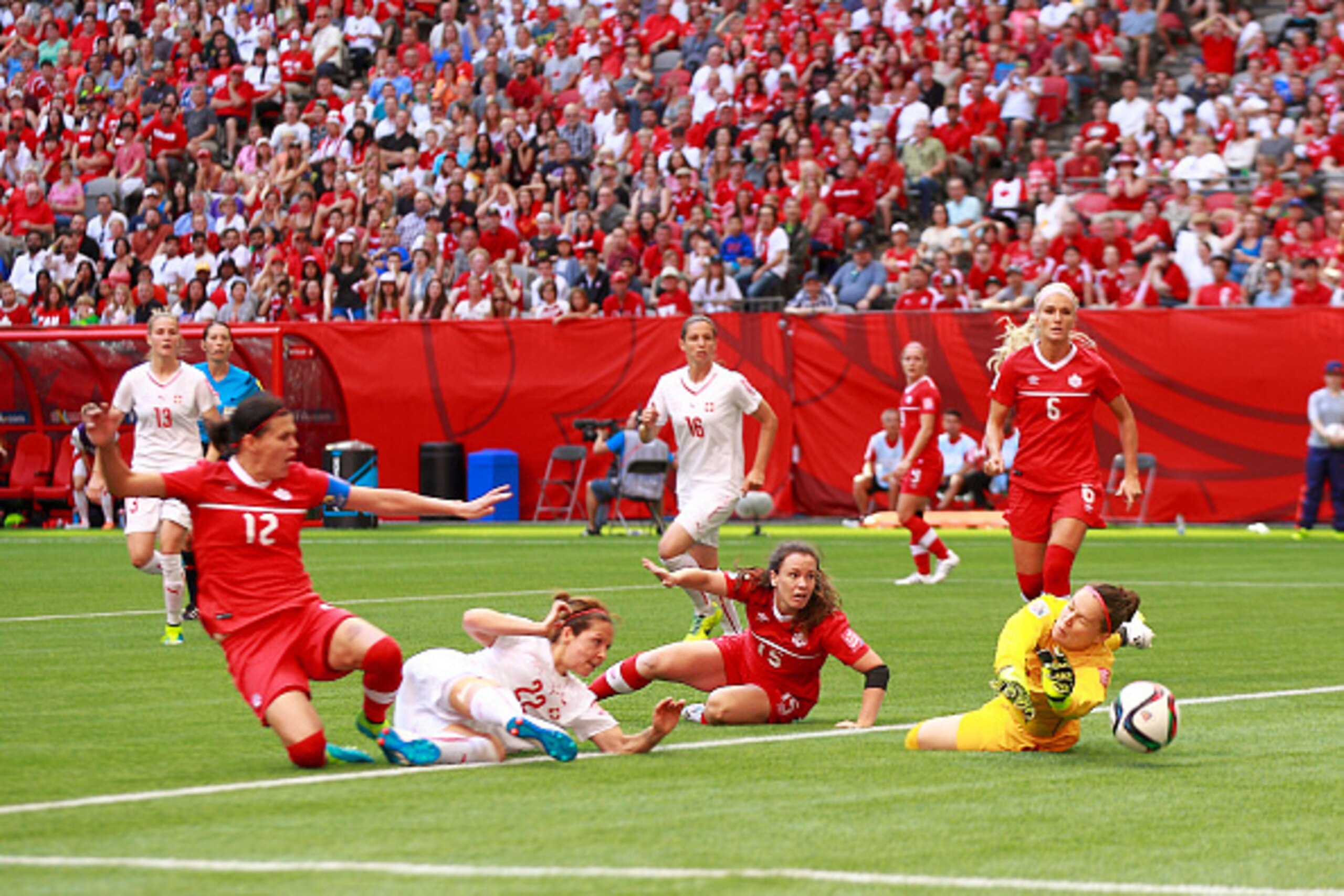 VANCOUVER, BC - JUNE 21: Christine Sinclair #12 and Allysha Chapman #15 of Canada look on as Erin McLeod #1 of Canada makes a save off the shot of Vanessa Bernauer #22 of Switzerland during the FIFA Women's World Cup Canada 2015 Round 16 match between Sw VANCOUVER, BC - JUNE 21: Christine Sinclair #12 and Allysha Chapman #15 of Canada look on as Erin McLeod #1 of Canada makes a save off the shot of Vanessa Bernauer #22 of Switzerland during the FIFA Women's World Cup Canada 2015 Round 16 match between Sw