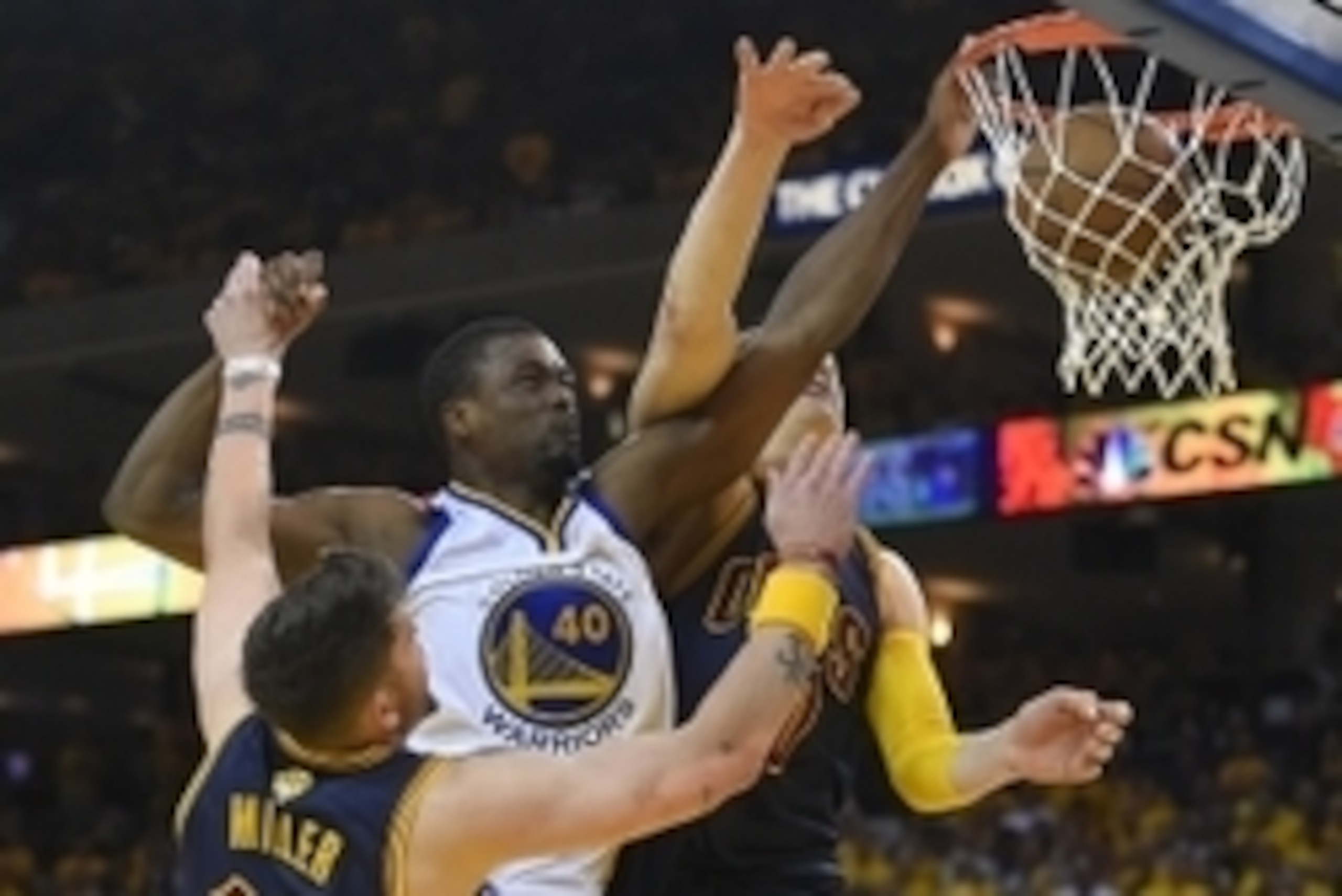 Jun 14, 2015; Oakland, CA, USA; Golden State Warriors forward Harrison Barnes (40) dunks the ball over Cleveland Cavaliers guard Mike Miller (18) and center Timofey Mozgov (20) during the fourth quarter in game five of the NBA Finals at Oracle Arena. Mand