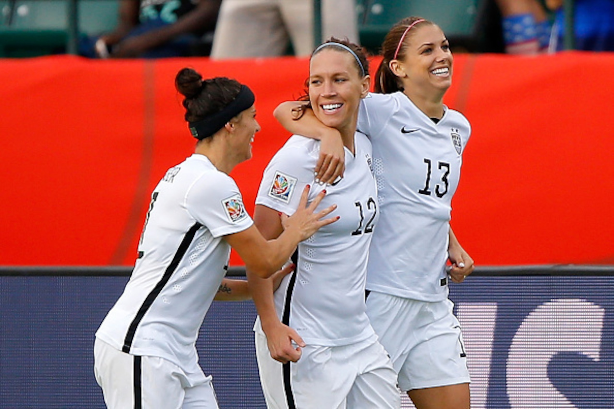 EDMONTON, AB - JUNE 22:  Alex Morgan #13 of the United States celebrates with teammates Lauren Holiday #12 and Alex Krieger #11 after Morgan scores her first goal against goalkeeper Stefany Castano #1 of Colombia in the second half in the FIFA Women's Wor