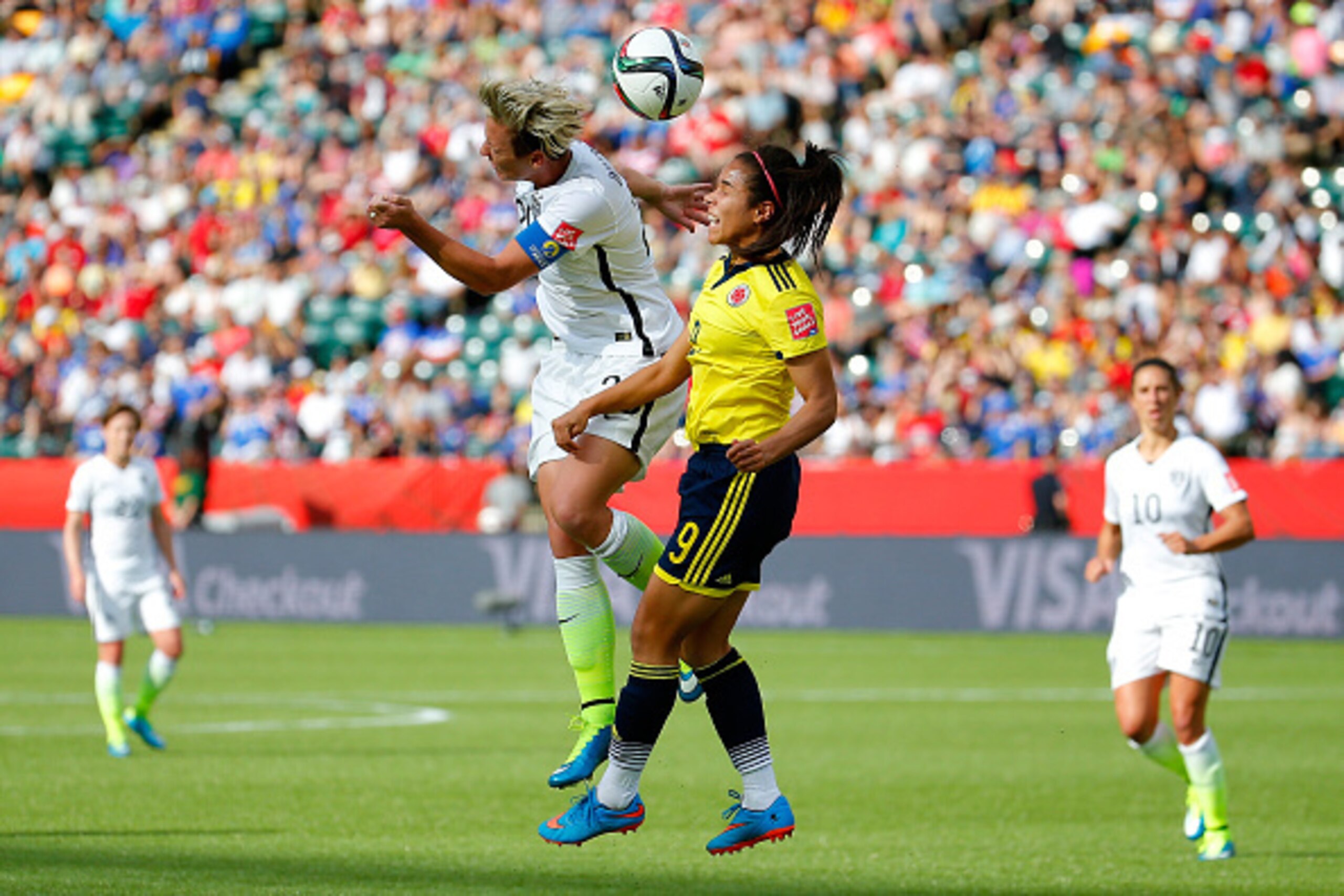 EDMONTON, AB - JUNE 22:  Abby Wambach #20 of the United States heads the ball against Orianica Velasquez #9 of Colombia in the first half in the FIFA Women's World Cup 2015 Round of 16 match at Commonwealth Stadium on June 22, 2015 in Edmonton, Canada.  (