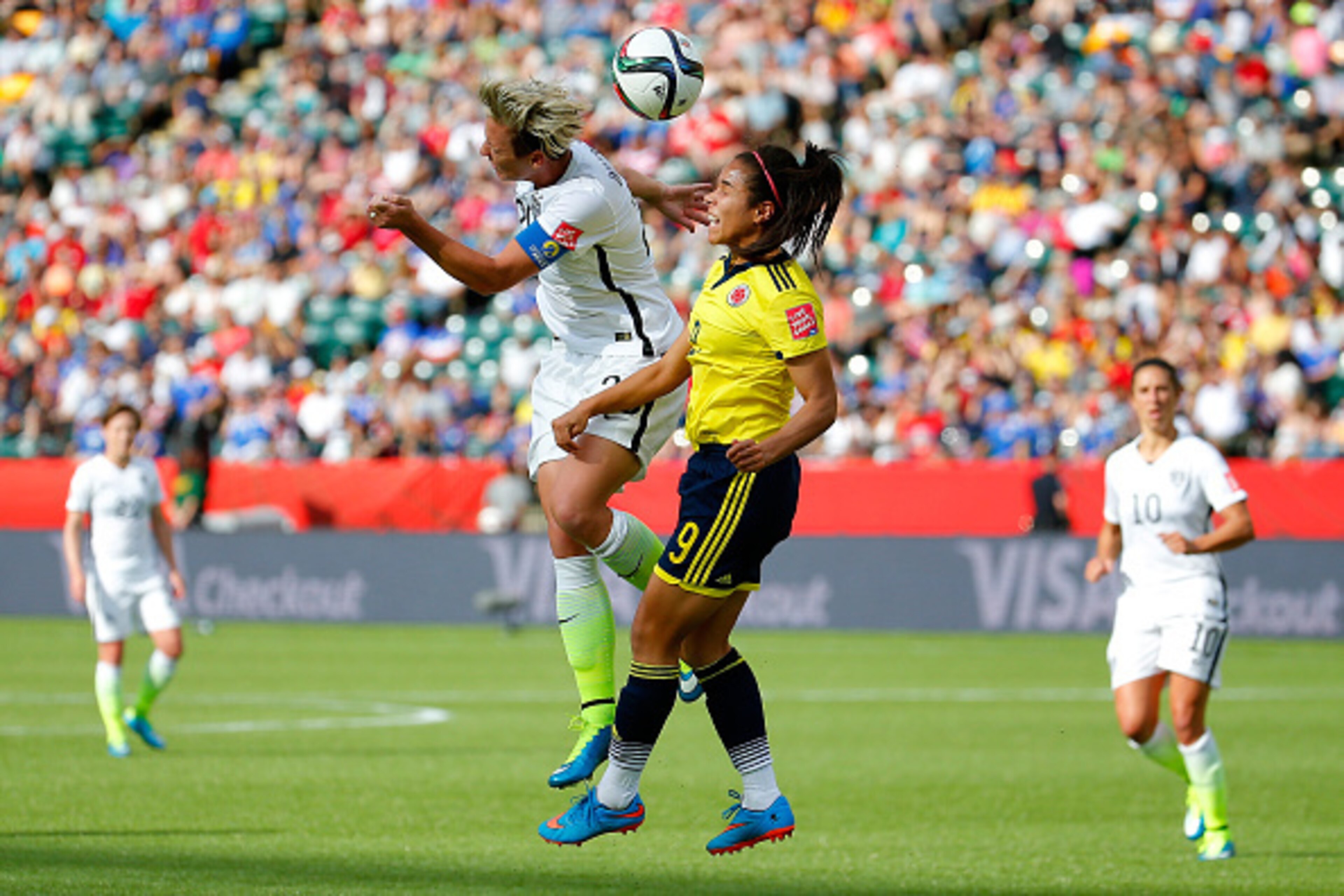 EDMONTON, AB - JUNE 22:  Abby Wambach #20 of the United States heads the ball against Orianica Velasquez #9 of Colombia in the first half in the FIFA Women's World Cup 2015 Round of 16 match at Commonwealth Stadium on June 22, 2015 in Edmonton, Canada.  (