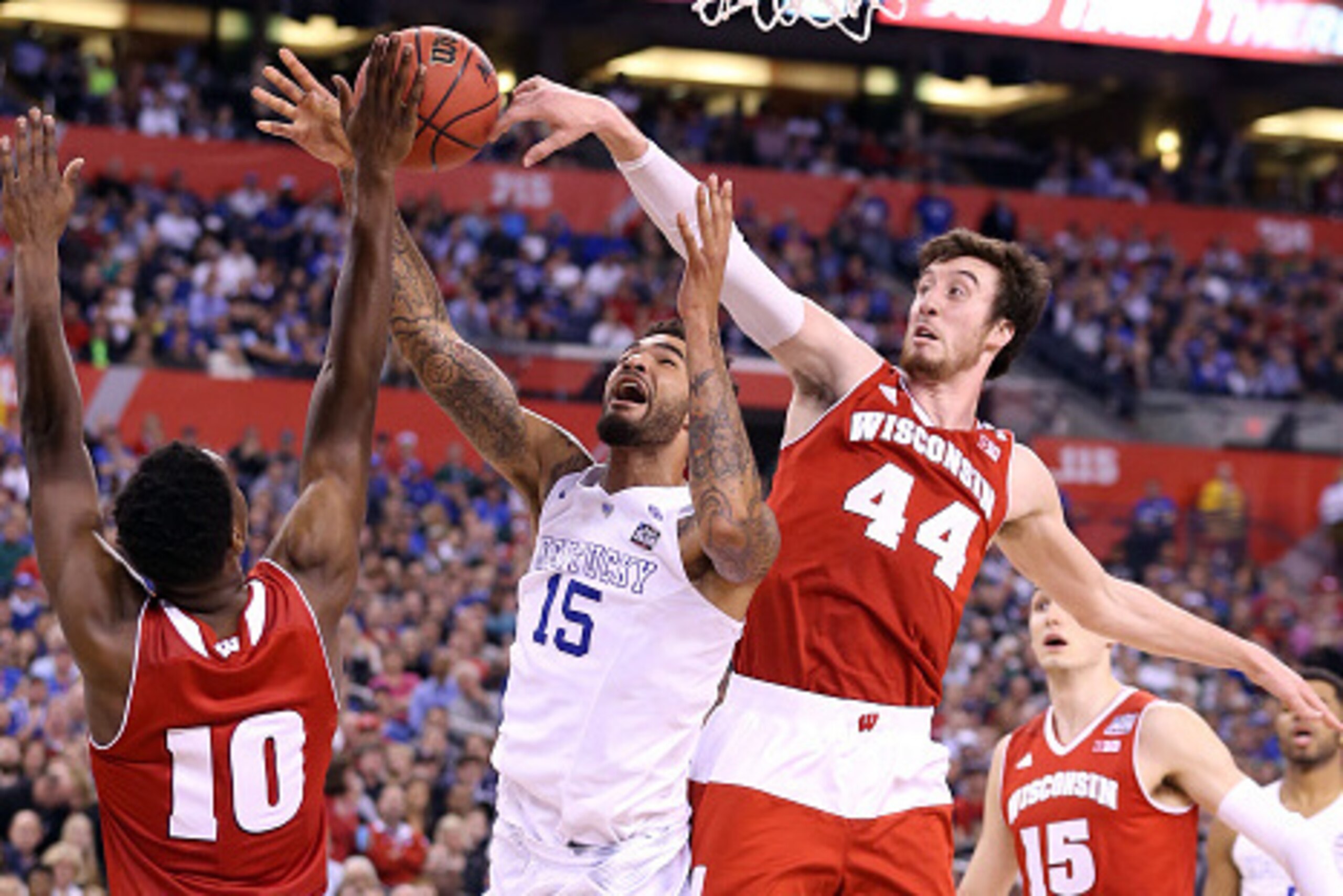 INDIANAPOLIS, IN - APRIL 04: Willie Cauley-Stein #15 of the Kentucky Wildcats goes up with the ball against Nigel Hayes #10 and Frank Kaminsky #44 of the Wisconsin Badgers in the second half during the NCAA Men's Final Four Semifinal at Lucas Oil Stadium 