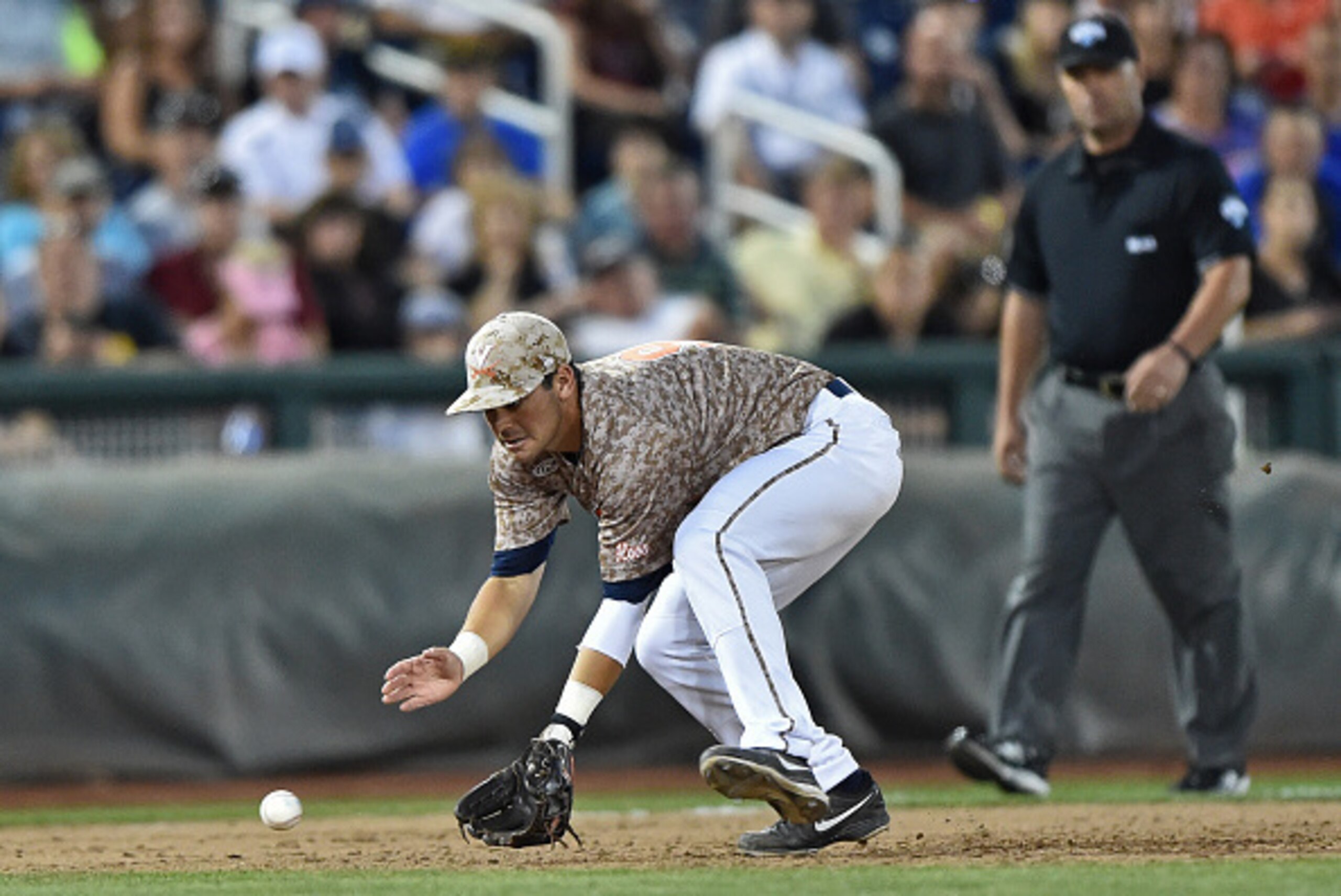 Omaha, NE - JUNE 22:  Third basemen Kenny Towns #9 of the Virginia Cavaliers comes in to field a ground ball against the Vanderbilt Commodores in the sixth inning during game one of the College World Series Championship Series on June 22, 2015 at TD Ameri