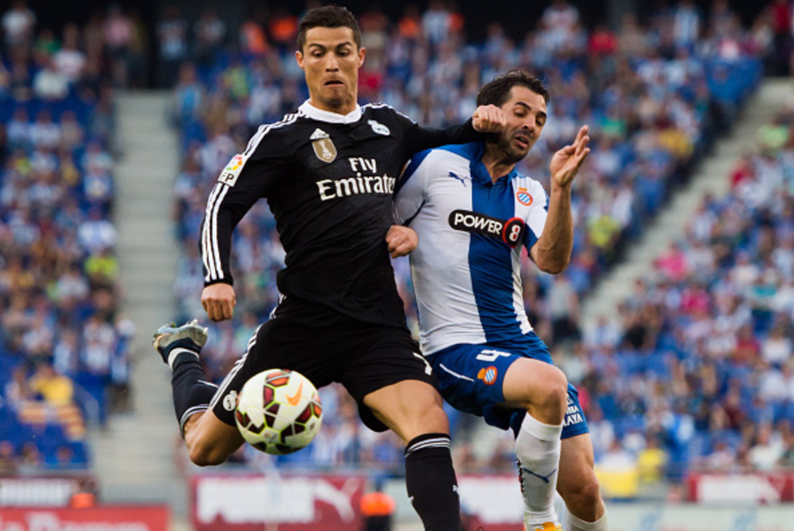 BARCELONA, SPAIN - MAY 17: Cristiano Ronaldo (L) of Real Madrid CF fights for the ball with Victor Sanchez (R) of RCD Espanyol during the La Liga match between RCD Espanyol and Real Madrid CF at Cornella-El Prat Stadium on May 17, 2015 in Barcelona, Spain