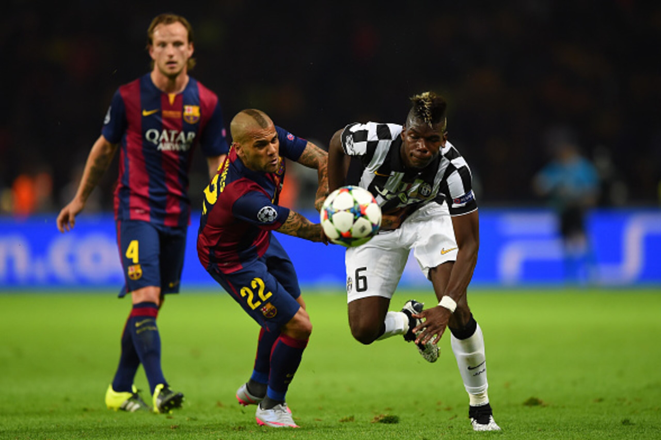 BERLIN, GERMANY - JUNE 06:  Paul Pogba of Juventus is tackled by Daniel Alves of Barcelona during the UEFA Champions League Final between Juventus and FC Barcelona at Olympiastadion on June 6, 2015 in Berlin, Germany.  (Photo by Shaun Botterill/Getty Imag