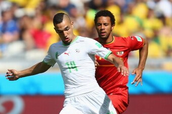 BELO HORIZONTE, BRAZIL - JUNE 17:  Nabil Bentaleb of Algeria controls the ball as Moussa Dembele of Belgium gives chase during the 2014 FIFA World Cup Brazil Group H match between Belgium and Algeria at Estadio Mineirao on June 17, 2014 in Belo Horizonte,