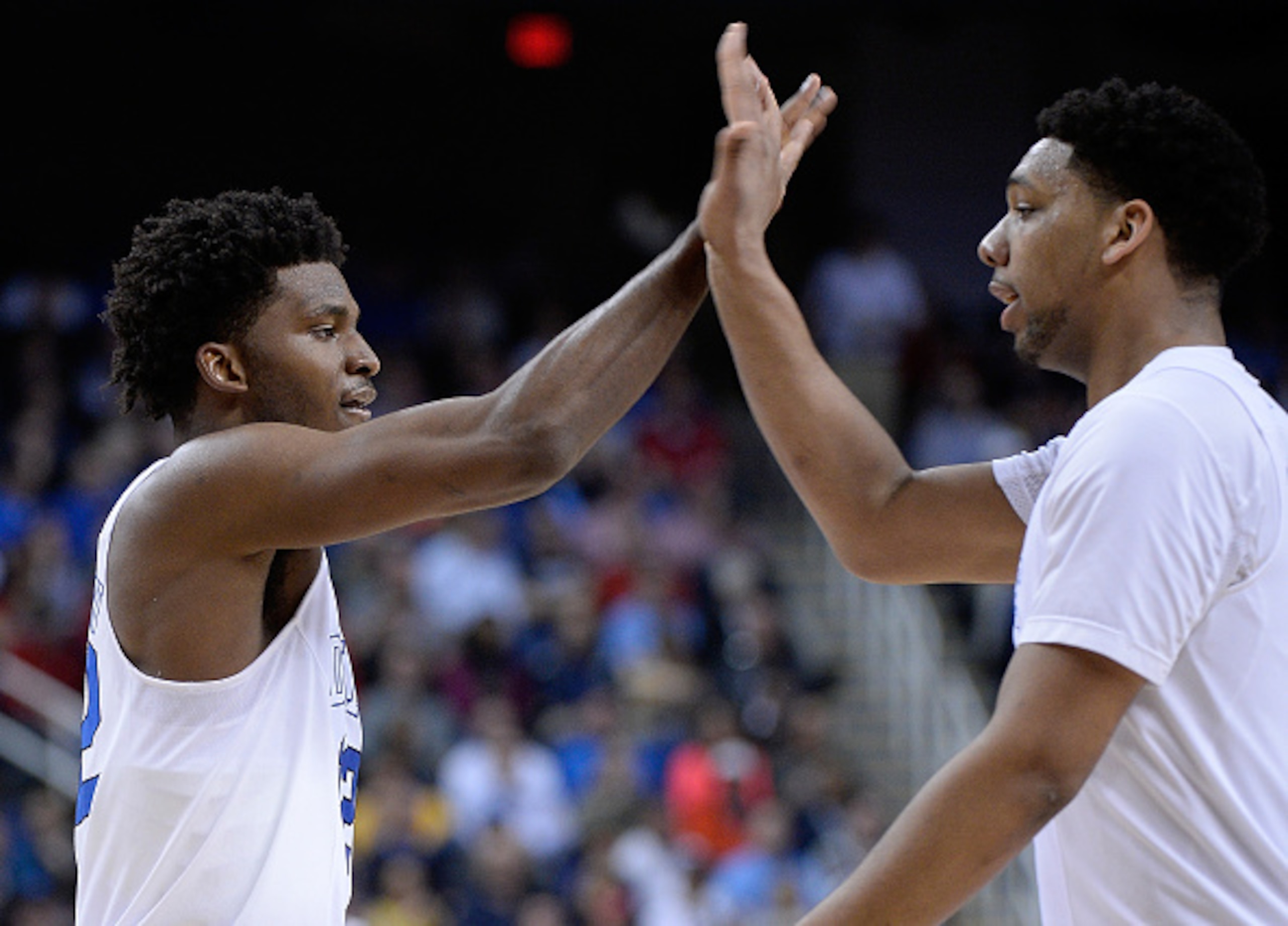 GREENSBORO, NC - MARCH 12:  Justise Winslow #12 and Jahlil Okafor #15 of the Duke Blue Devils high-five during theit game against the North Carolina State Wolfpack during the quarterfinals of the ACC Basketball Tournament at Greensboro Coliseum on March 1