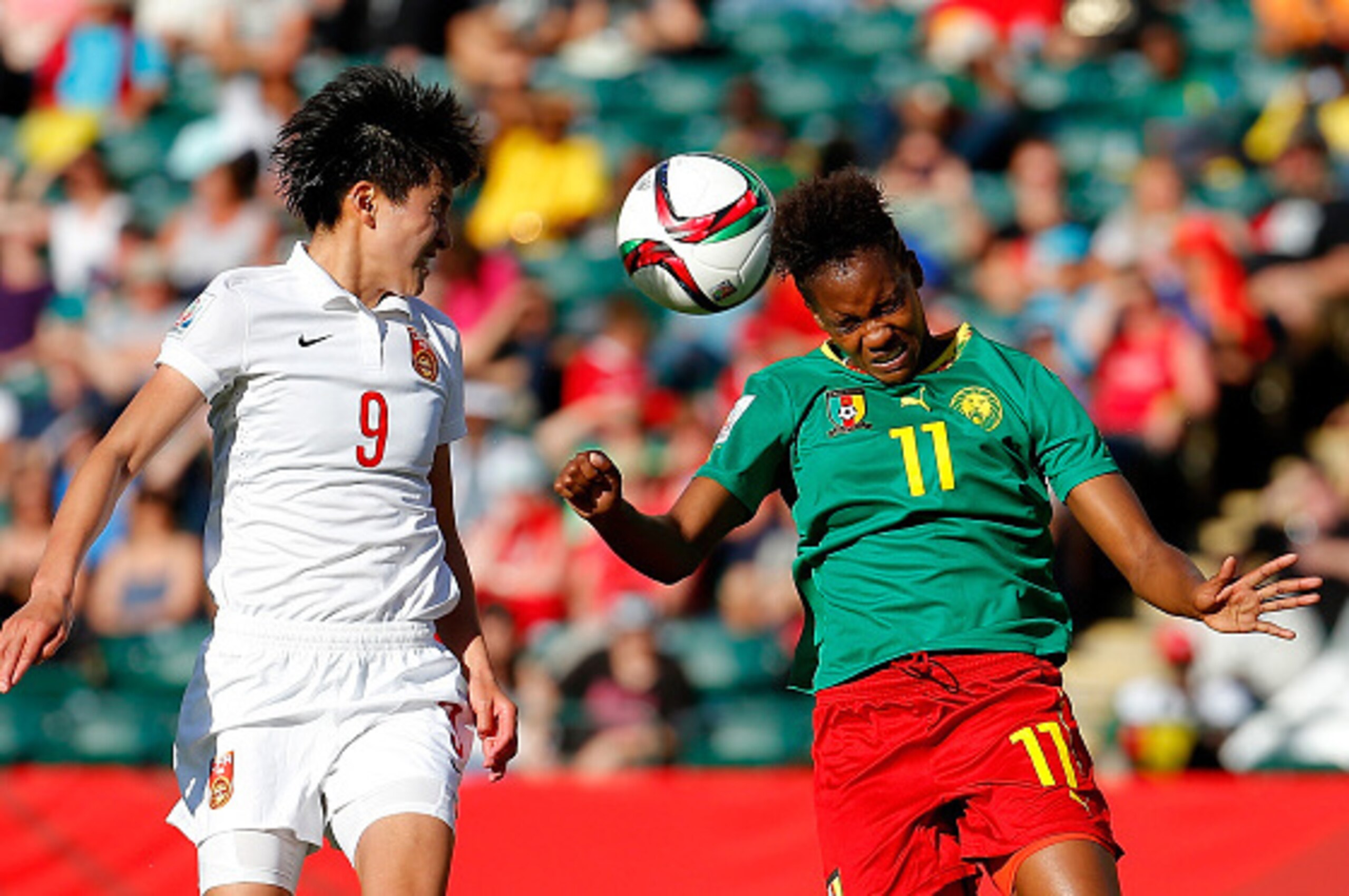 EDMONTON, AB - JUNE 20:  Aurelle Awona #11 of Cameroon battles for a header against Wang Shanshan #9 of China PR during the FIFA Women's World Canada 2015 Round of 16 match between China PR and Cameroon at Commonwealth Stadium on June 20, 2015 in Edmonton
