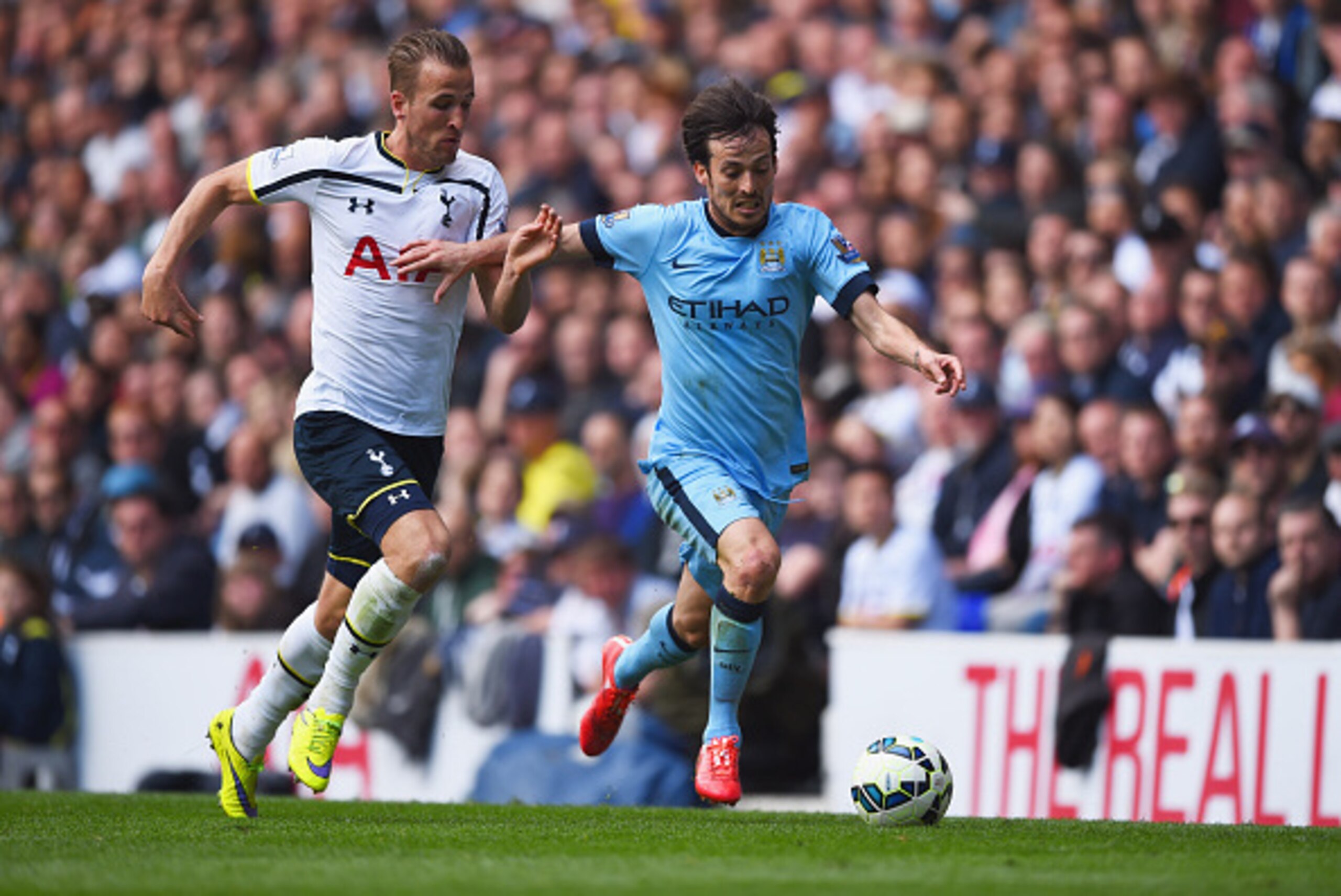 LONDON, ENGLAND - MAY 03:  David Silva of Manchester City holds off Harry Kane of Spurs during the Barclays Premier League match between Tottenham Hotspur and Manchester City at White Hart Lane on May 3, 2015 in London, England.  (Photo by Shaun Botterill