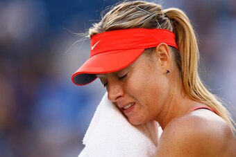 INDIAN WELLS, CA - MARCH 14:  Maria Sharapova of Russia wipes her face against Yanina Wickmayer of Belgium during day six of the BNP Paribas Open tennis at the Indian Wells Tennis Garden on March 14, 2015 in Indian Wells, California.  (Photo by Julian Fin