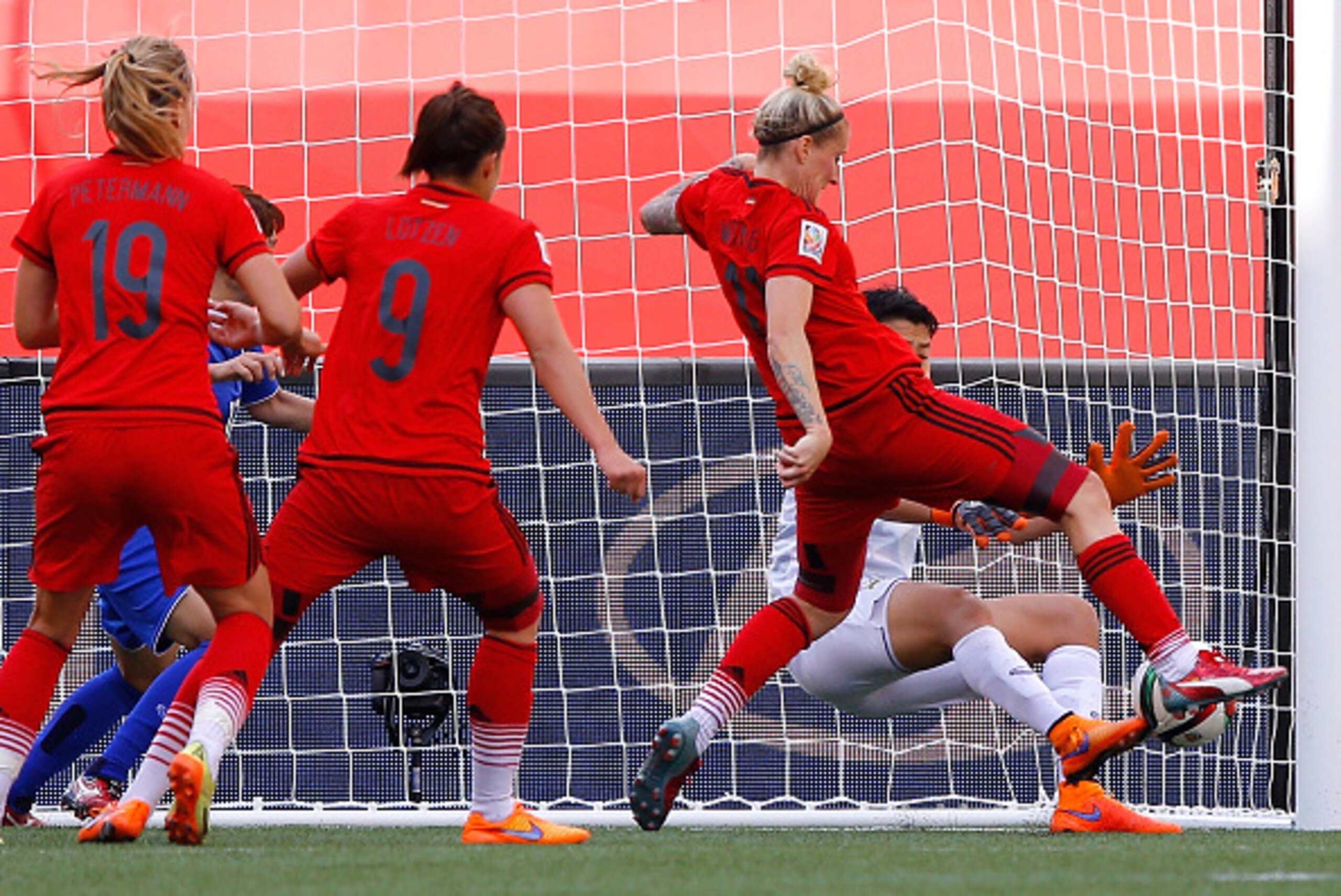 WINNIPEG, MB - JUNE 15: Goalkeeper Waraporn Boonsing #1 of Thailand saves a shot attempt by Anja Mittag #11 of Germany during the FIFA Women's World Cup Canada 2015 match between Thailand and Germany at Winnipeg Stadium on June 15, 2015 in Winnipeg, Cana WINNIPEG, MB - JUNE 15: Goalkeeper Waraporn Boonsing #1 of Thailand saves a shot attempt by Anja Mittag #11 of Germany during the FIFA Women's World Cup Canada 2015 match between Thailand and Germany at Winnipeg Stadium on June 15, 2015 in Winnipeg, Cana