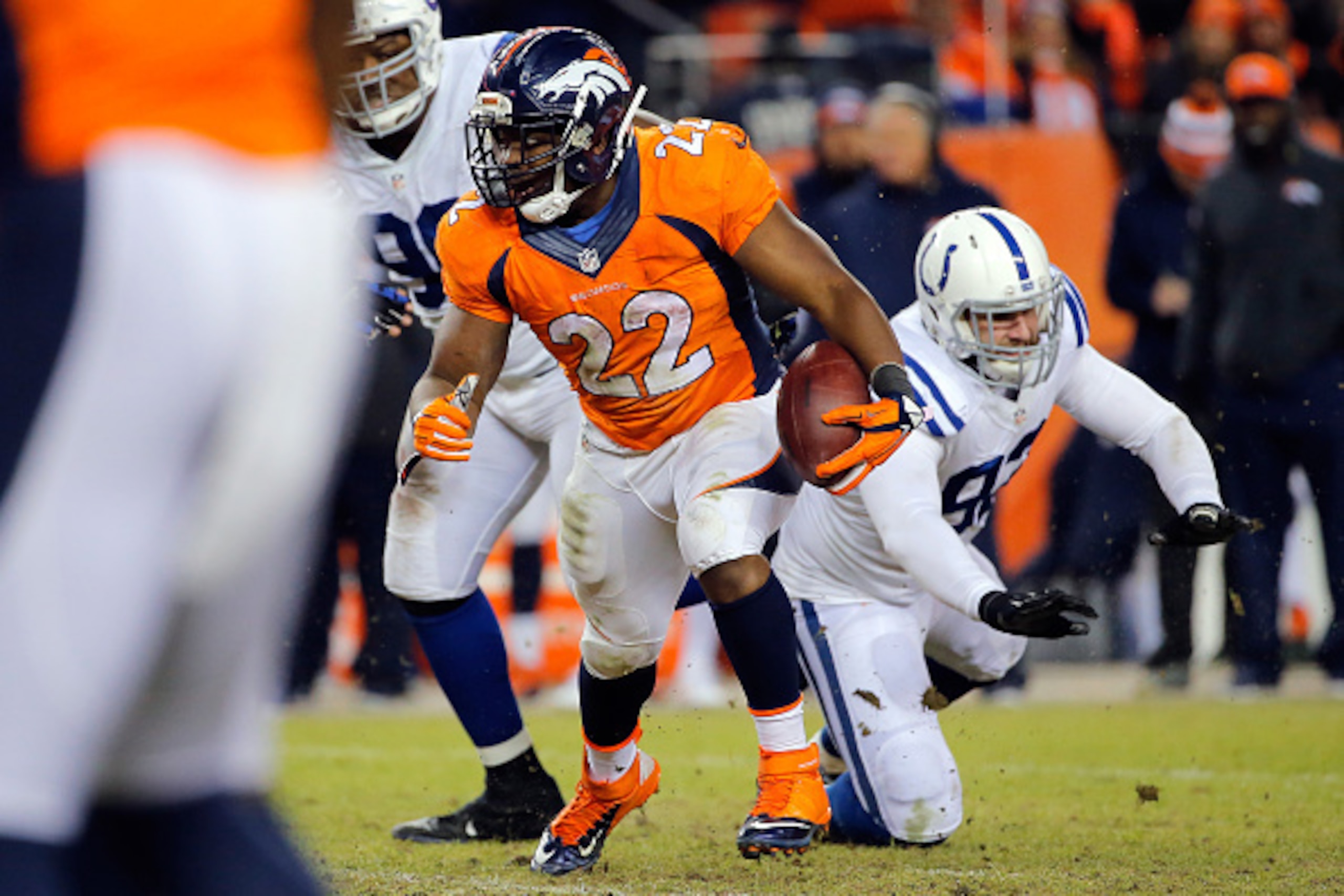 DENVER, CO - JANUARY 11:  C.J. Anderson #22 of the Denver Broncos rushes against the Indianapolis Colts   during a 2015 AFC Divisional Playoff game at Sports Authority Field at Mile High on January 11, 2015 in Denver, Colorado.  (Photo by Doug Pensinger/G