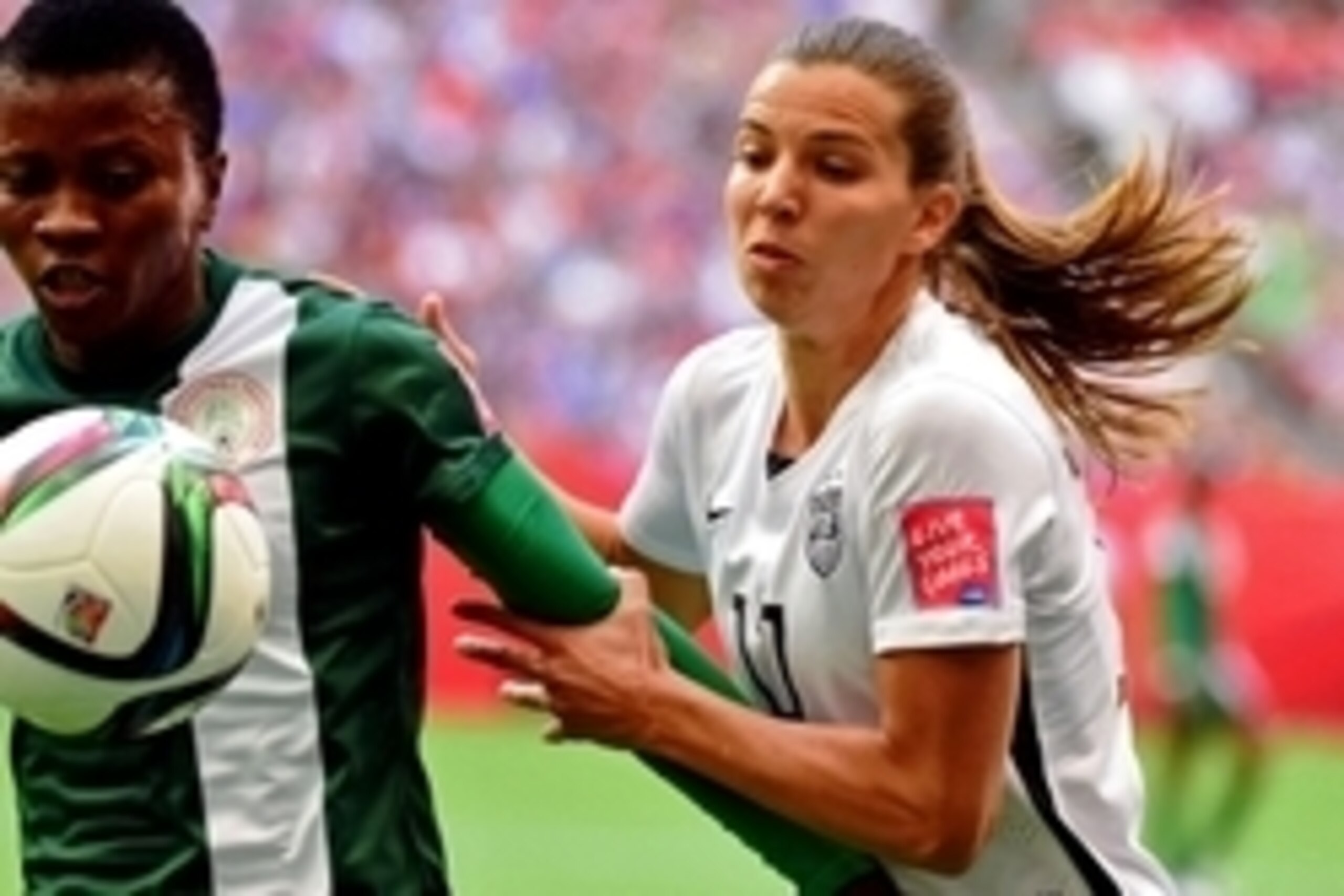 Jun 16, 2015; Vancouver, British Columbia, CAN; United States midfielder Tobin Heath (17) and Nigeria midfielder Evelyn Nwabuoku (14) battles for the ball against during the first half in a Group D soccer match in the 2015 FIFA women's World Cup at BC Pla