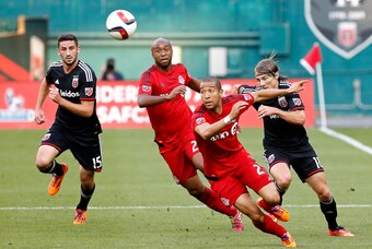Jun 6, 2015; Washington, DC, USA; Toronto FC defender Justin Morrow (2) and D.C. United forward Chris Rolfe (18) chase the ball in the first half at Robert F. Kennedy Memorial Stadium. Mandatory Credit: Geoff Burke-USA TODAY Sports