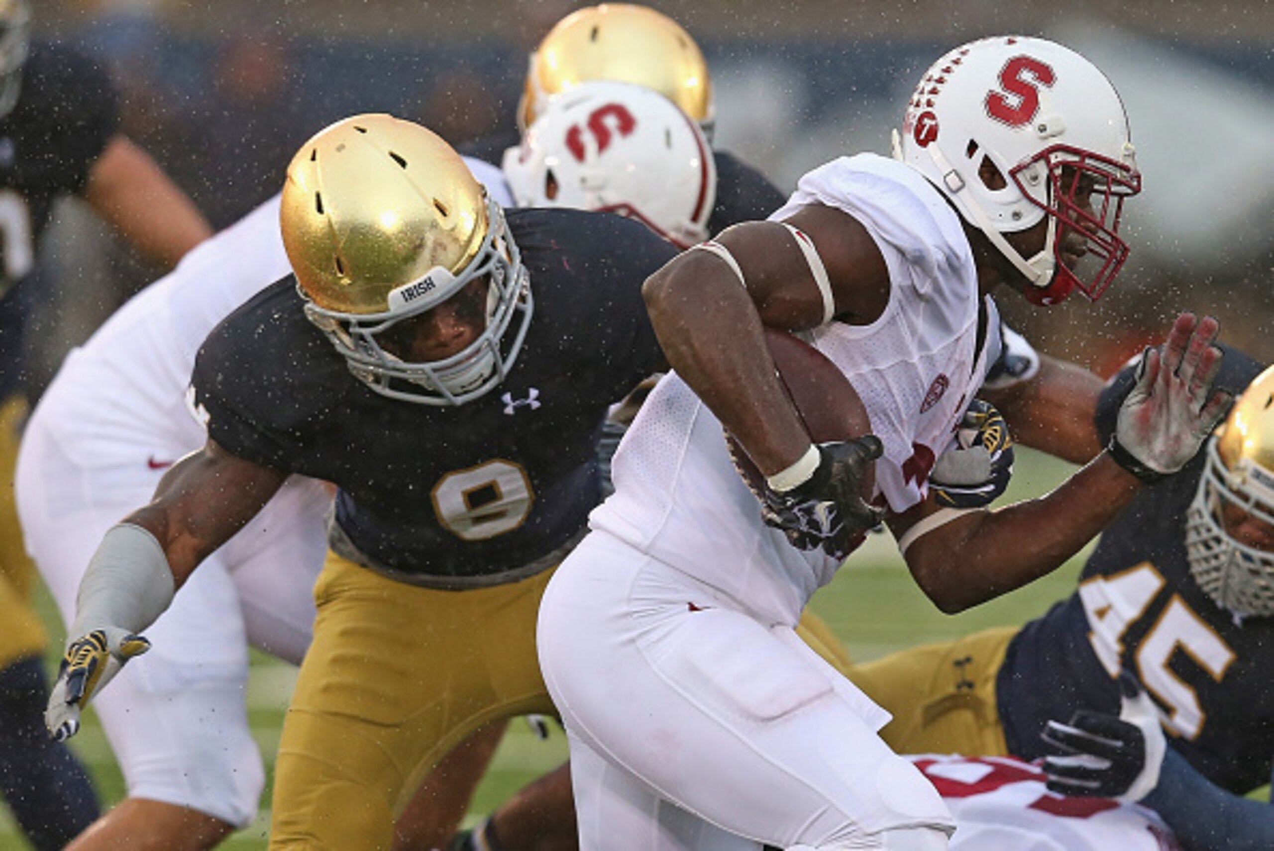 SOUTH BEND, IN - OCTOBER 04: Ty Montgomery #7 of the Standford Cardinal runs past Jaylon Smith #9 of the Notre Dame Fighting Irish at Notre Dame Stadium on October 4, 2014 in South Bend, Indiana.  (Photo by Jonathan Daniel/Getty Images)