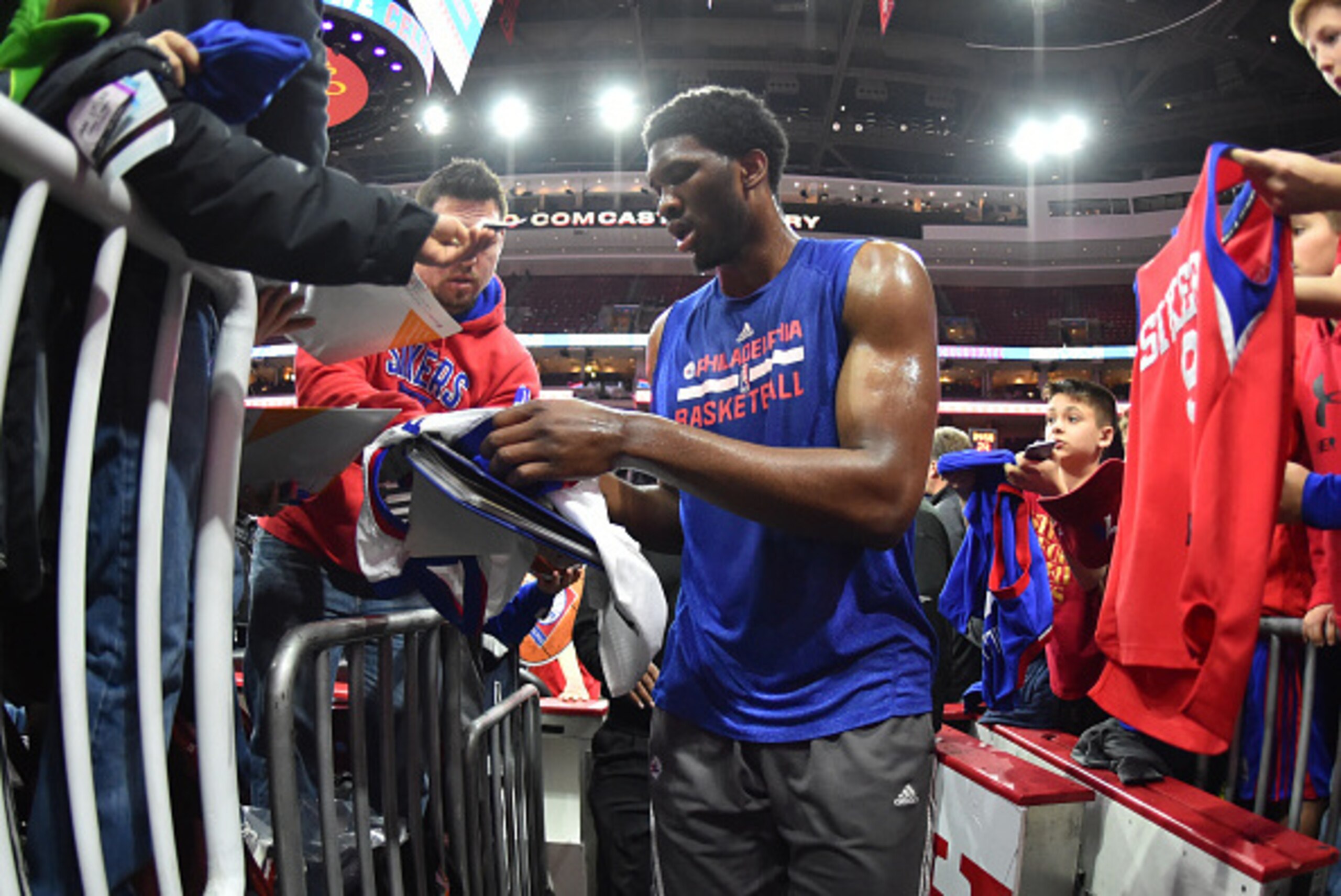 PHILADELPHIA,PA - FEBRUARY 27: Joel Embiid #21 of the Philadelphia 76ers signs autographs prior to the game against the Washington Wizards at Wells Fargo Center on February 27, 2015 in Philadelphia, Pennsylvania NOTE TO USER: User expressly acknowledges a