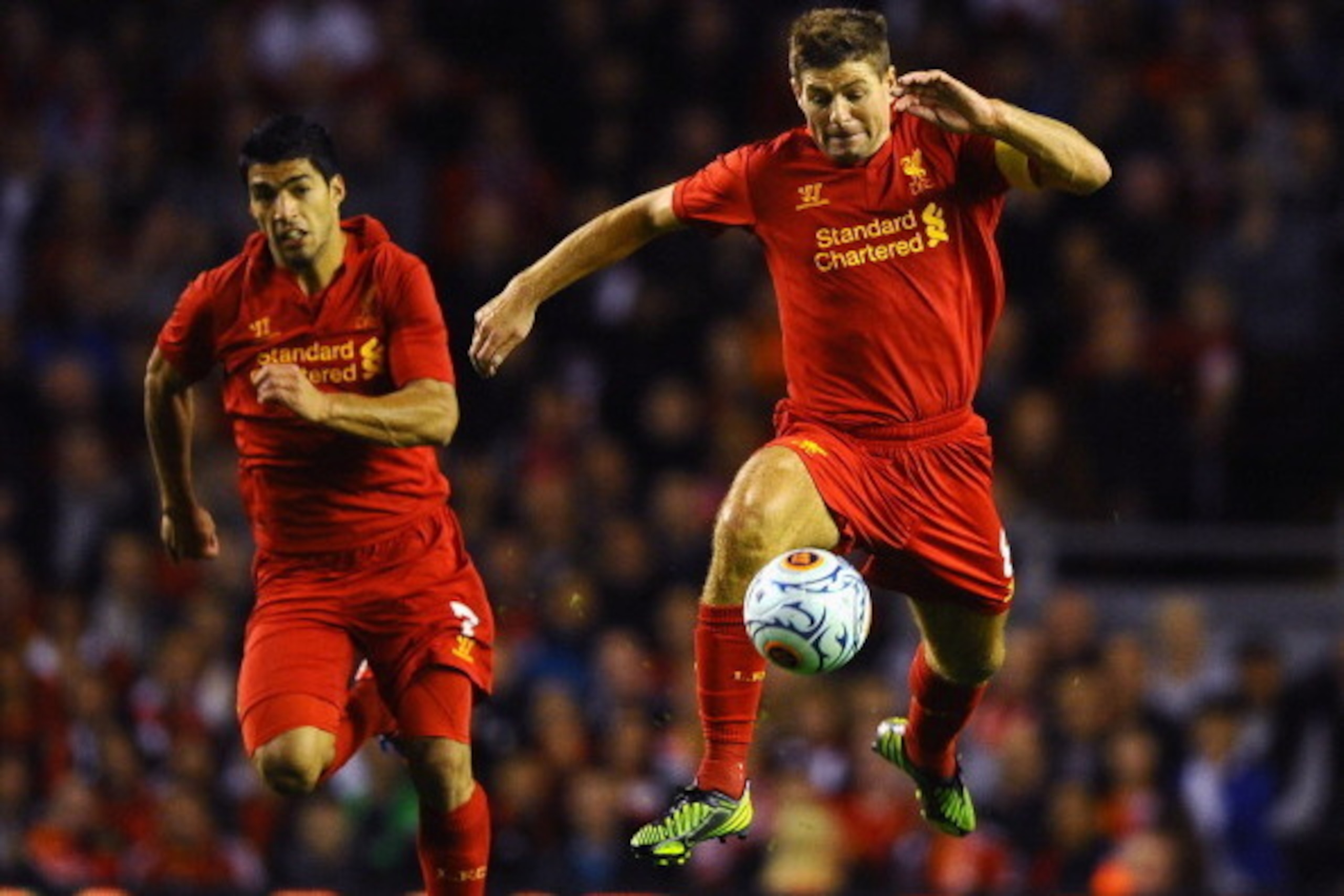 LIVERPOOL, ENGLAND - AUGUST 30: Steven Gerrard of Liverpool runs alongside Luis Suarez during the UEFA Europa League play-off round second leg between Liverpool and Hearts at Anfield on August 30, 2012 in Liverpool, England.  (Photo by Laurence Griffiths/