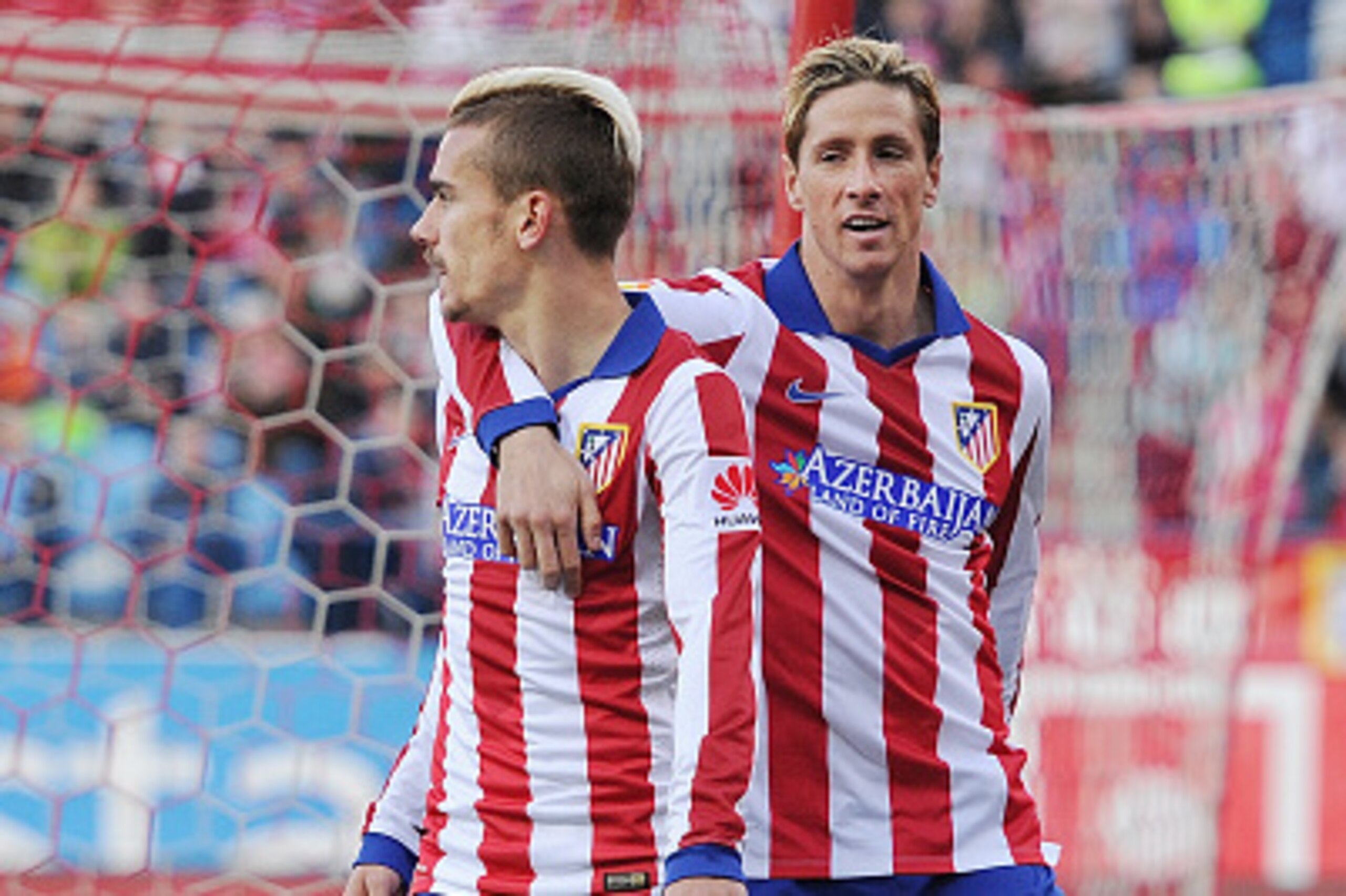 MADRID, SPAIN - APRIL 07:  Antoine Griezmann of Club Atletico de Madrid celebrates with Fernando Torres after scoring his team's 2nd goal during the La Liga match between Club Atletico de Madrid and Real Sociedad at Vicente Calderon Stadium on April 7, 20