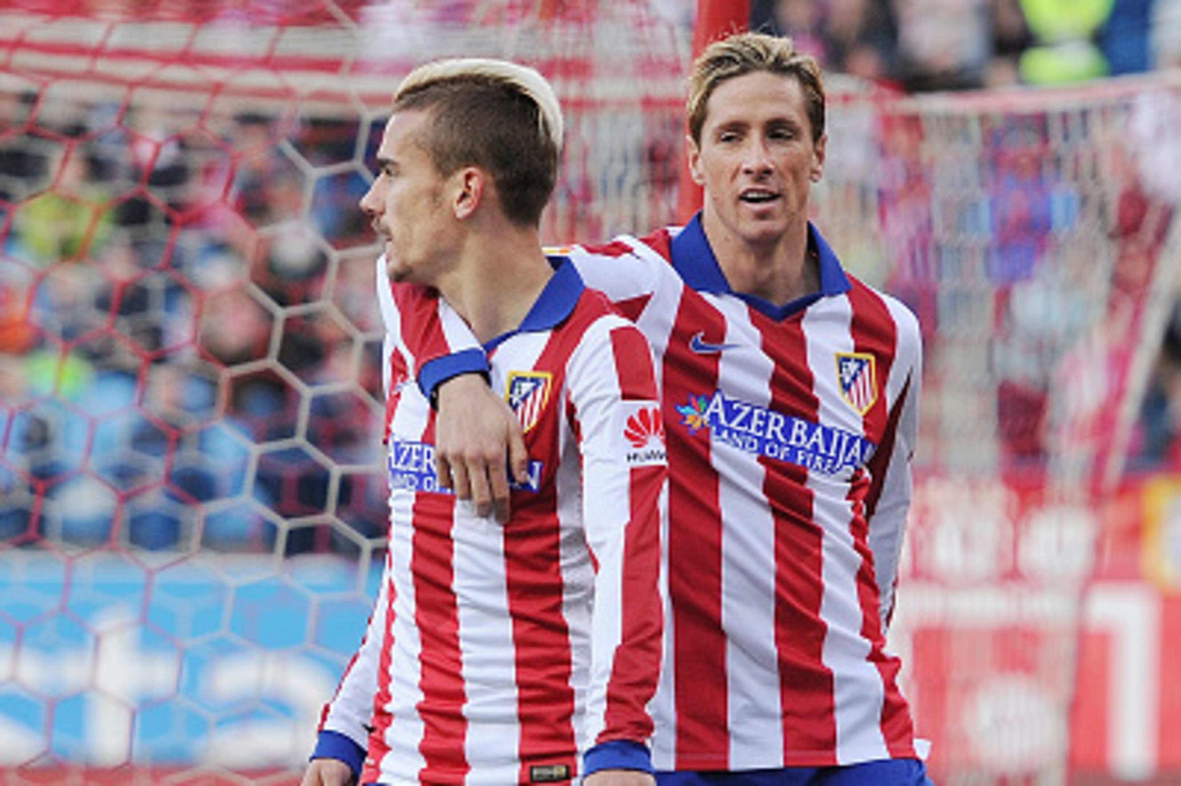 MADRID, SPAIN - APRIL 07:  Antoine Griezmann of Club Atletico de Madrid celebrates with Fernando Torres after scoring his team's 2nd goal during the La Liga match between Club Atletico de Madrid and Real Sociedad at Vicente Calderon Stadium on April 7, 20
