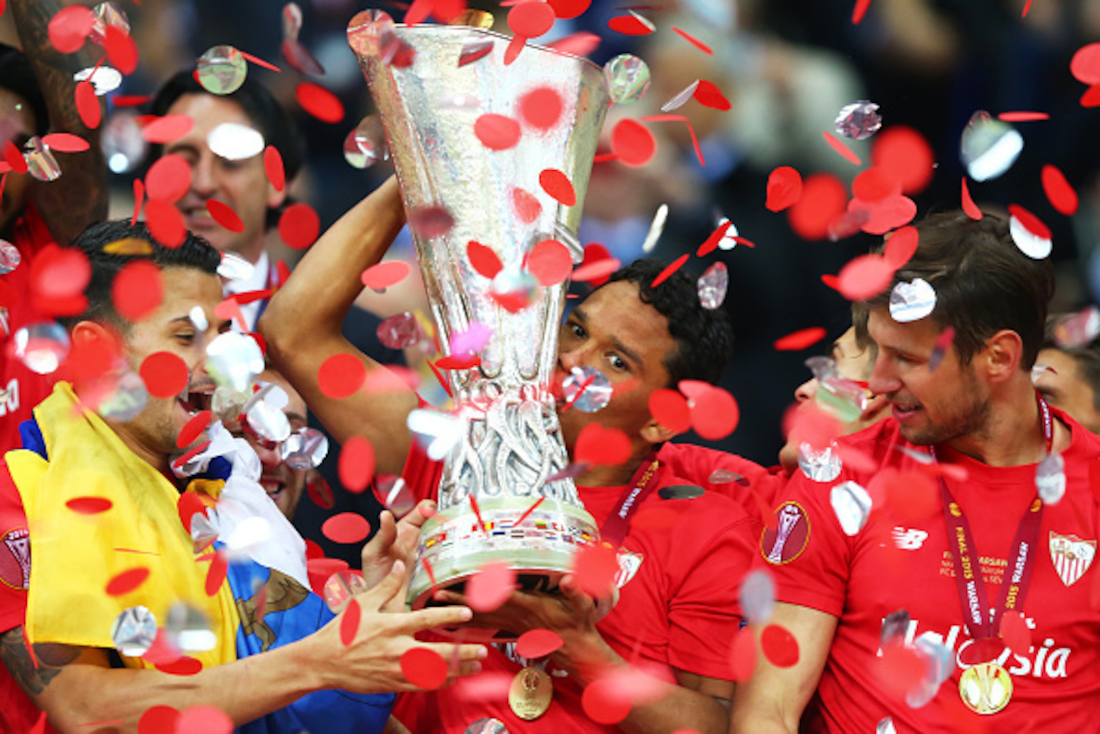 WARSAW, POLAND - MAY 27:  Carlos Bacca of Sevilla celebrates victory with the trophy after the UEFA Europa League Final match between FC Dnipro Dnipropetrovsk and FC Sevilla on May 27, 2015 in Warsaw, Poland.  (Photo by Martin Rose/Getty Images)