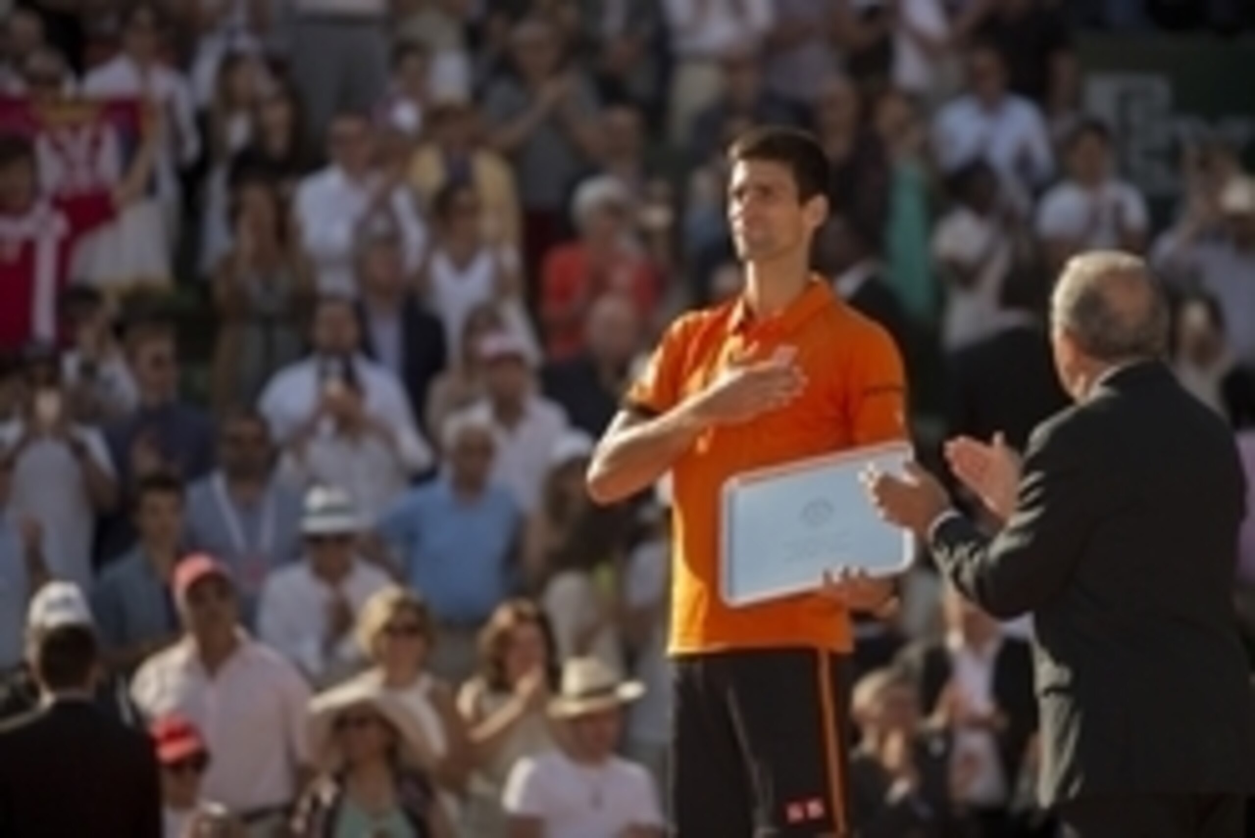 Jun 7, 2015; Paris, France; Novak Djokovic (SRB) receives his finalist trophy from FFT president Jean Gachassin (R) after his match against Stan Wawrinka (SUI) on day 15 of the 2015 French Open at Roland Garros. Mandatory Credit: Susan Mullane-USA TODAY S
