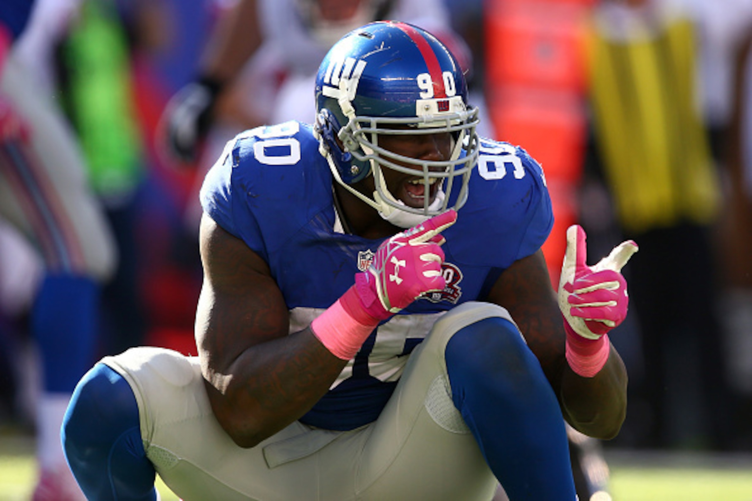 EAST RUTHERFORD, NJ - OCTOBER 05:  Defensive end Jason Pierre-Paul #90 of the New York Giants reacts after a play in the fourth quarter against the Atlanta Falcons during their game at MetLife Stadium on October 5, 2014 in East Rutherford, New Jersey.  (P