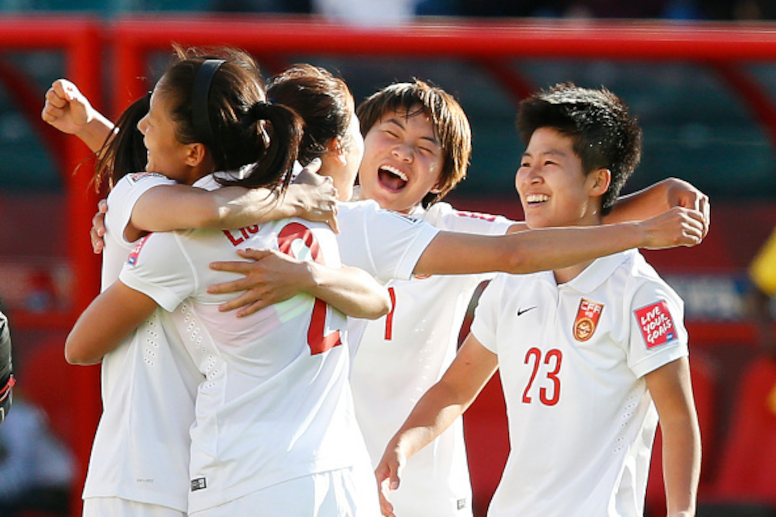 EDMONTON, AB - JUNE 20: Team members of China celebrate their win over Cameroon during the FIFA Women's World Cup Canada Round 16 match between China and Cameroon at Commonwealth Stadium on June 20, 2015 in Edmonton, Alberta, Canada. (Photo by Todd Korol/