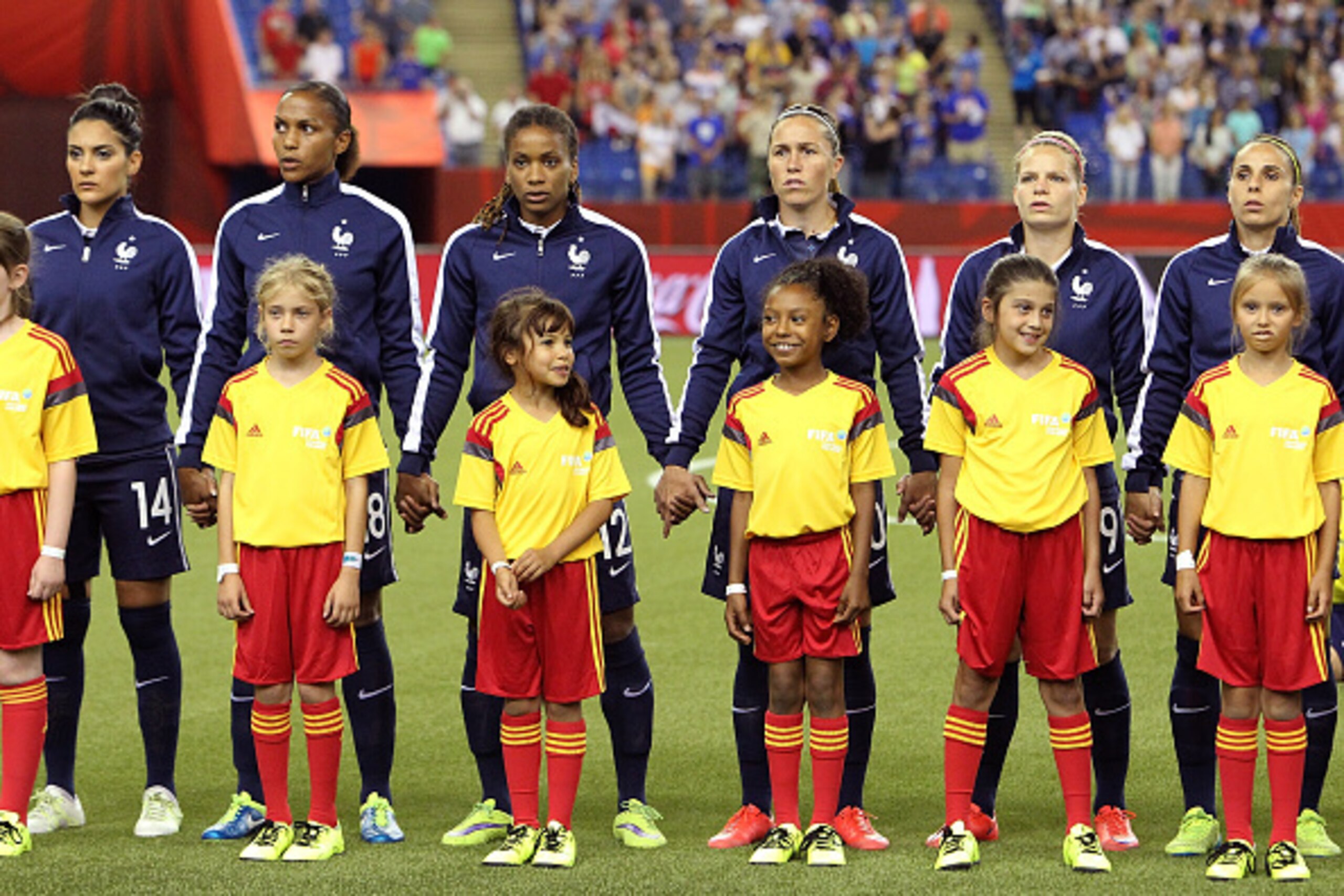 MONTREAL, QC - JUNE 21: Team France stand in line during the national anthem prior to the FIFA Women's World Cup Canada 2015 round of 16 match between France and Korea Republic at Olympic Stadium on June 21, 2015 in Montreal, Canada.  (Photo by Francois L