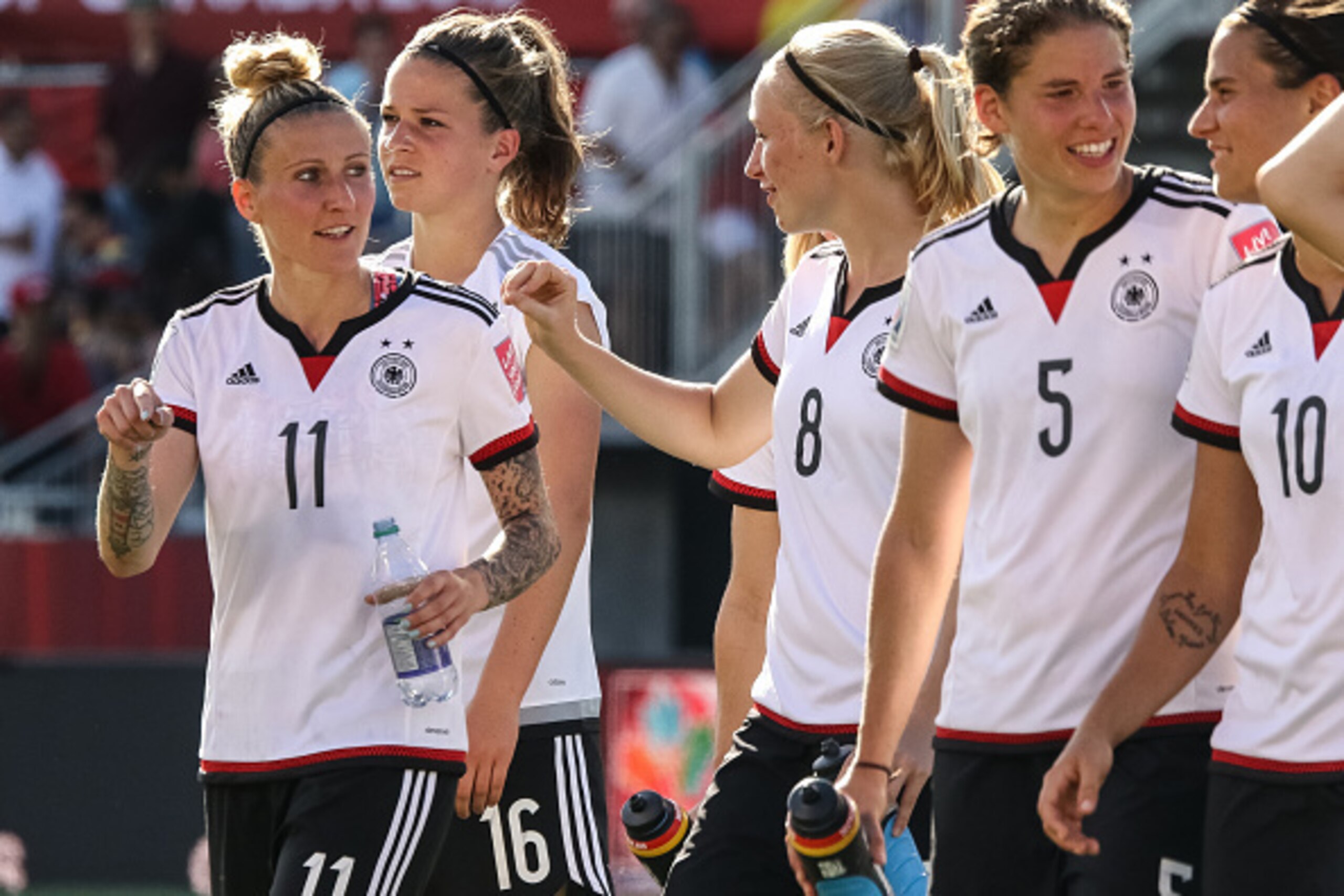 OTTAWA, ON - JUNE 20: Anja Mittag #11 and Pauline Bremer #8 of Germany celebrate their win after the FIFA Women's World Cup Canada 2015 round of 16 match between Germany and Sweden at Lansdowne Stadium on June 20, 2015 in Ottawa, Canada.  (Photo by Andre 