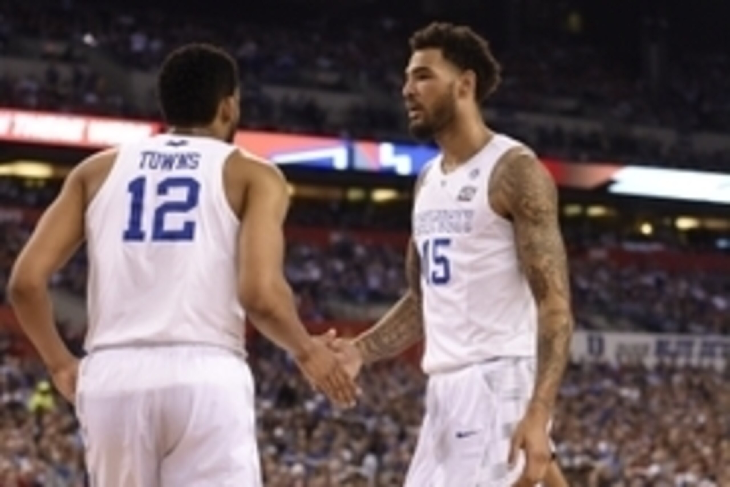 Apr 4, 2015; Indianapolis, IN, USA; Kentucky Wildcats forward Karl-Anthony Towns (12) and forward Willie Cauley-Stein (15) celebrate a basket against the Wisconsin Badgers in the first half of the 2015 NCAA Men's Division I Championship semi-final game at