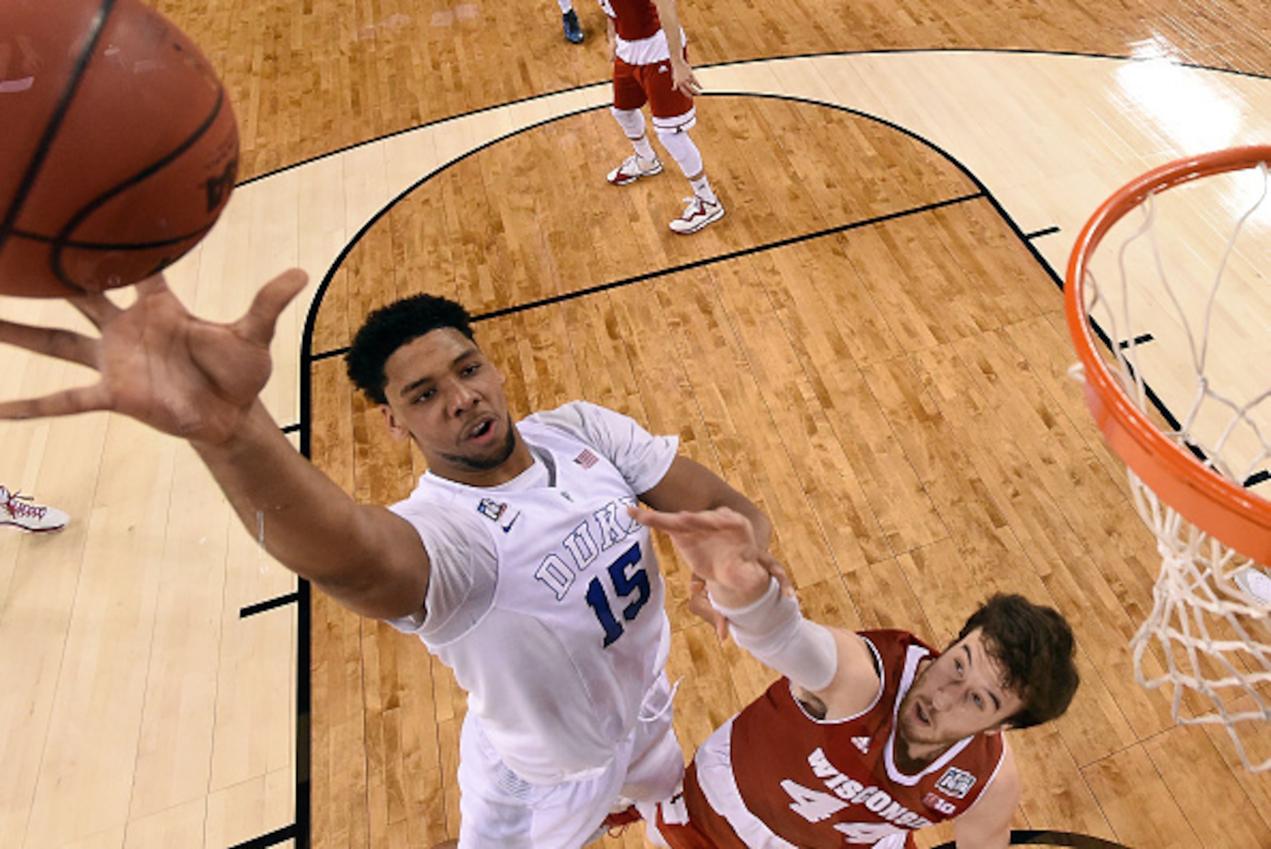 INDIANAPOLIS, IN - APRIL 06: Jahlil Okafor #15 of the Duke Blue Devils goes up with the ball against Frank Kaminsky #44 of the Wisconsin Badgers in the first half during the NCAA Men's Final Four National Championship at Lucas Oil Stadium on April 6, 2015 INDIANAPOLIS, IN - APRIL 06: Jahlil Okafor #15 of the Duke Blue Devils goes up with the ball against Frank Kaminsky #44 of the Wisconsin Badgers in the first half during the NCAA Men's Final Four National Championship at Lucas Oil Stadium on April 6, 2015