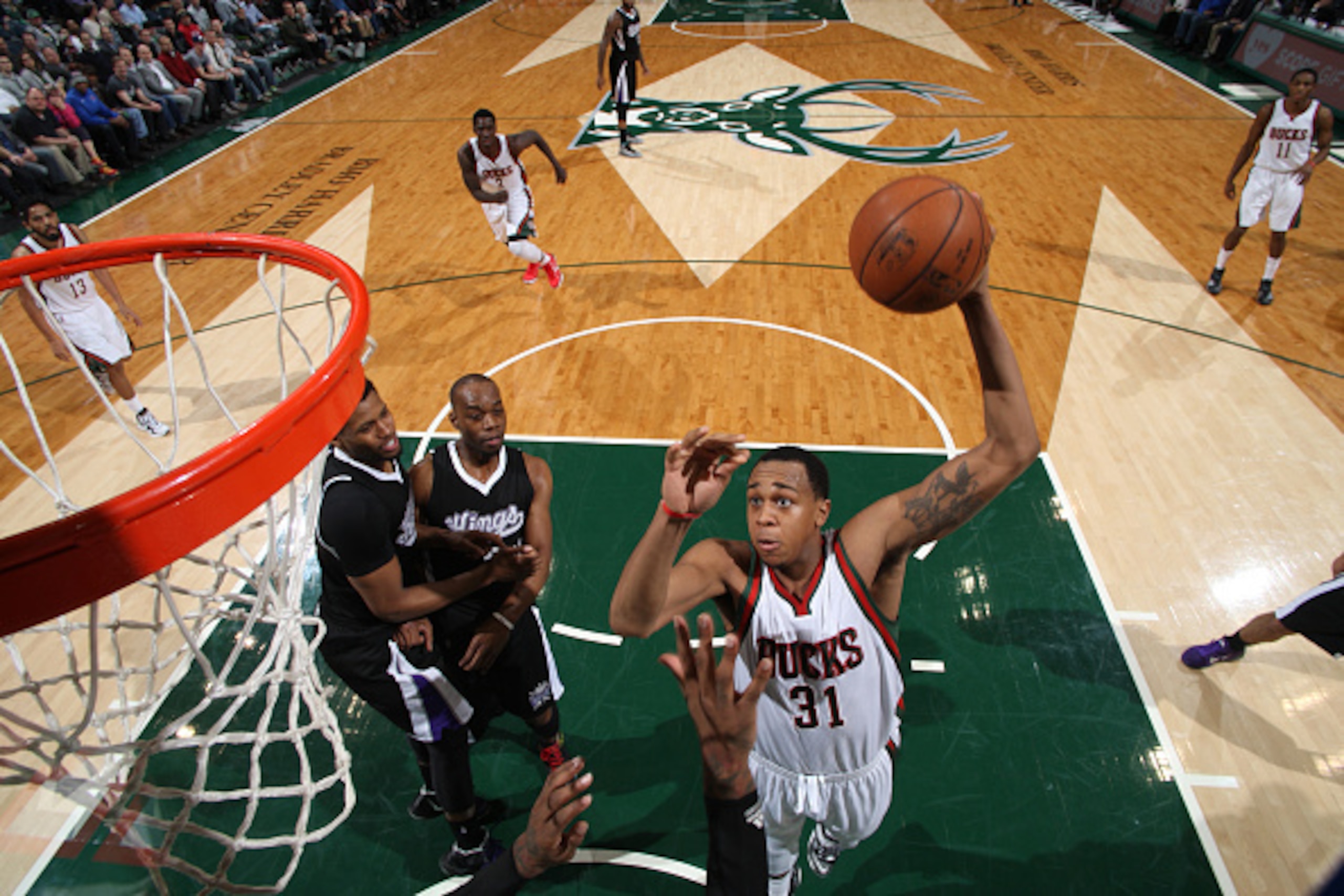 MILWAUKEE, WI -  FEBRUARY 11: John Henson #31 of the Milwaukee Bucks goes up for a dunk against the Sacramento Kings on February 11, 2015 at BMO Harris Bradley Center in Milwaukee, Wisconsin . NOTE TO USER: User expressly acknowledges and agrees that, by 