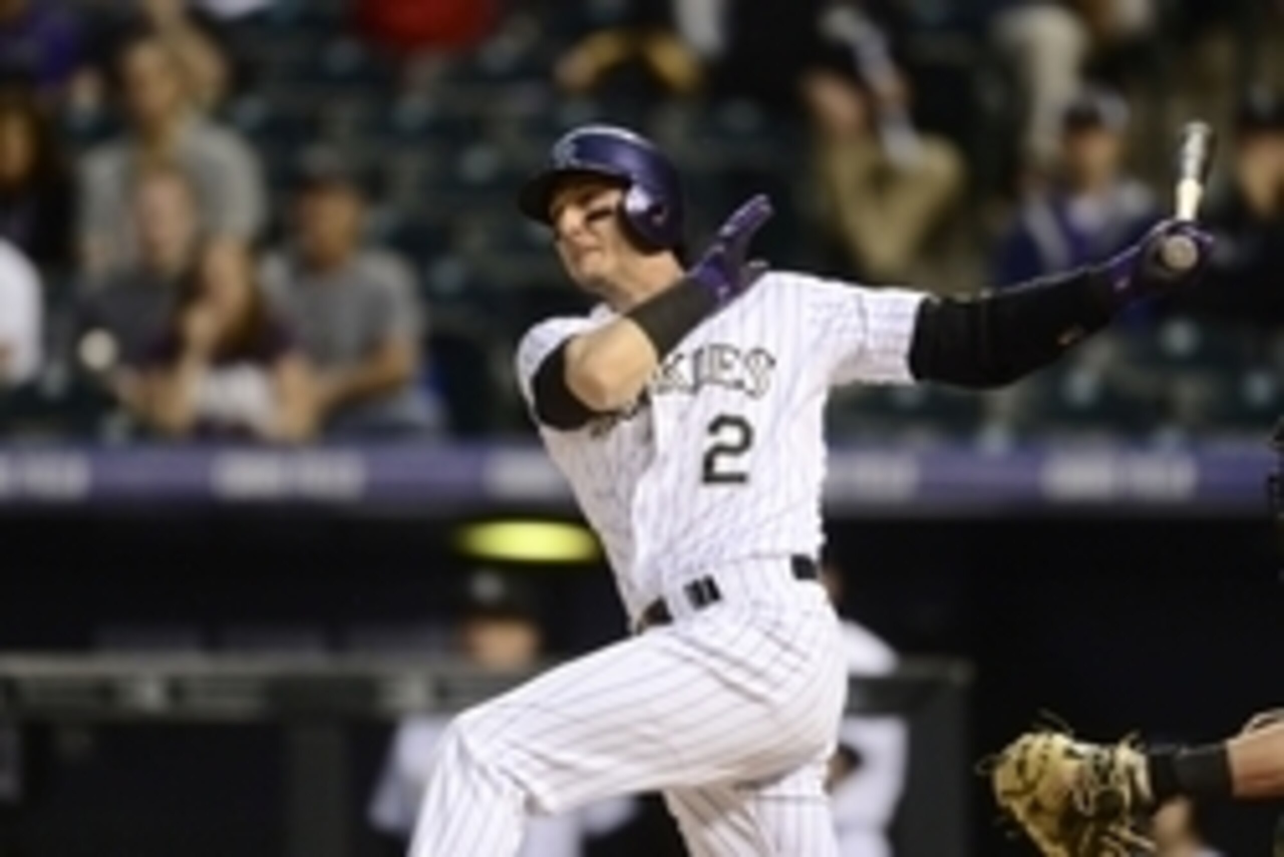 Jun 24, 2015; Denver, CO, USA; Colorado Rockies shortstop Troy Tulowitzki (2) hits a RBI single in the first inning against the Arizona Diamondbacks at Coors Field. Mandatory Credit: Ron Chenoy-USA TODAY Sports
