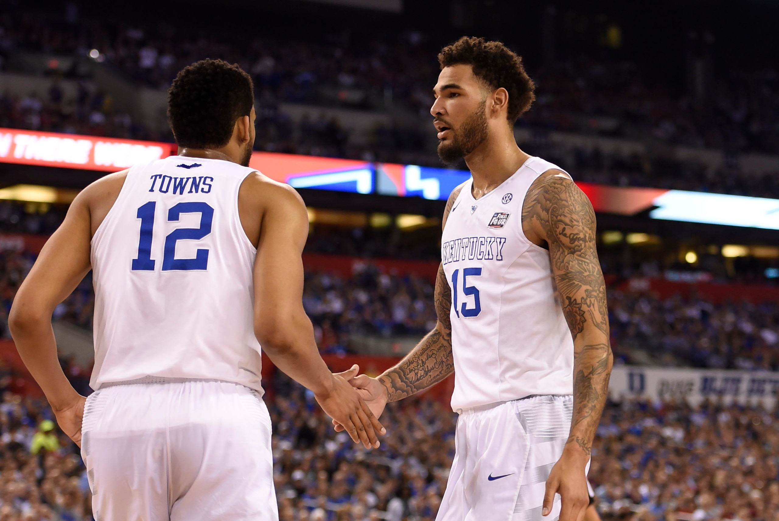 Apr 4, 2015; Indianapolis, IN, USA; Kentucky Wildcats forward Karl-Anthony Towns (12) and forward Willie Cauley-Stein (15) celebrate a basket against the Wisconsin Badgers in the first half of the 2015 NCAA Men's Division I Championship semi-final game at