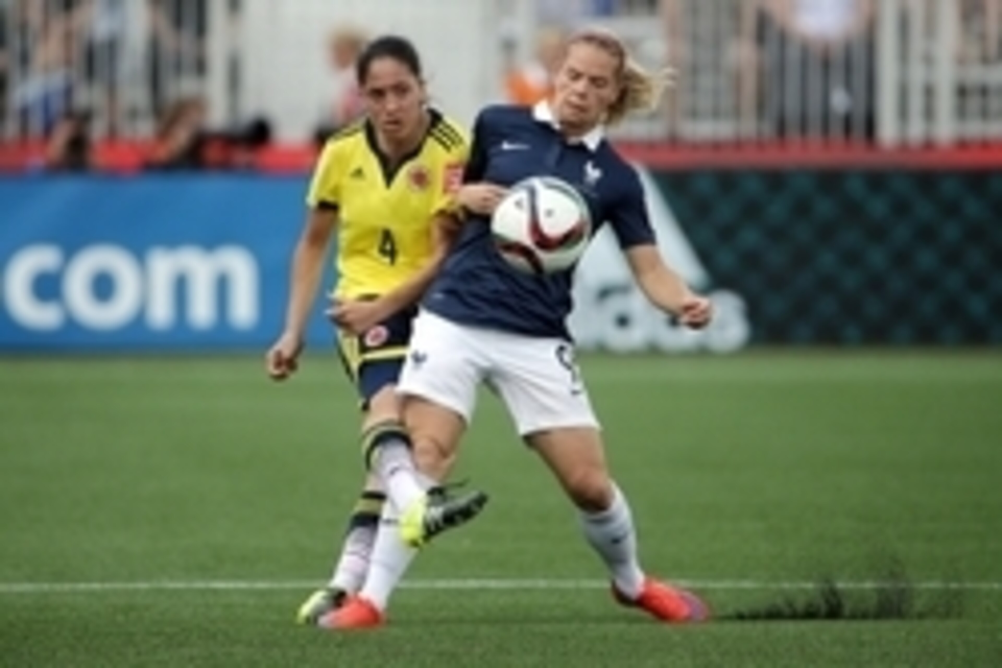 Jun 13, 2015; Moncton, New Brunswick, CAN; Colombia midfielder Diana Ospina (4) kicks the ball against France forward Eugenie Le Sommer (9) during the second half in a Group F soccer match in the 2015 FIFA women's World Cup at Moncton Stadium. Mandatory C