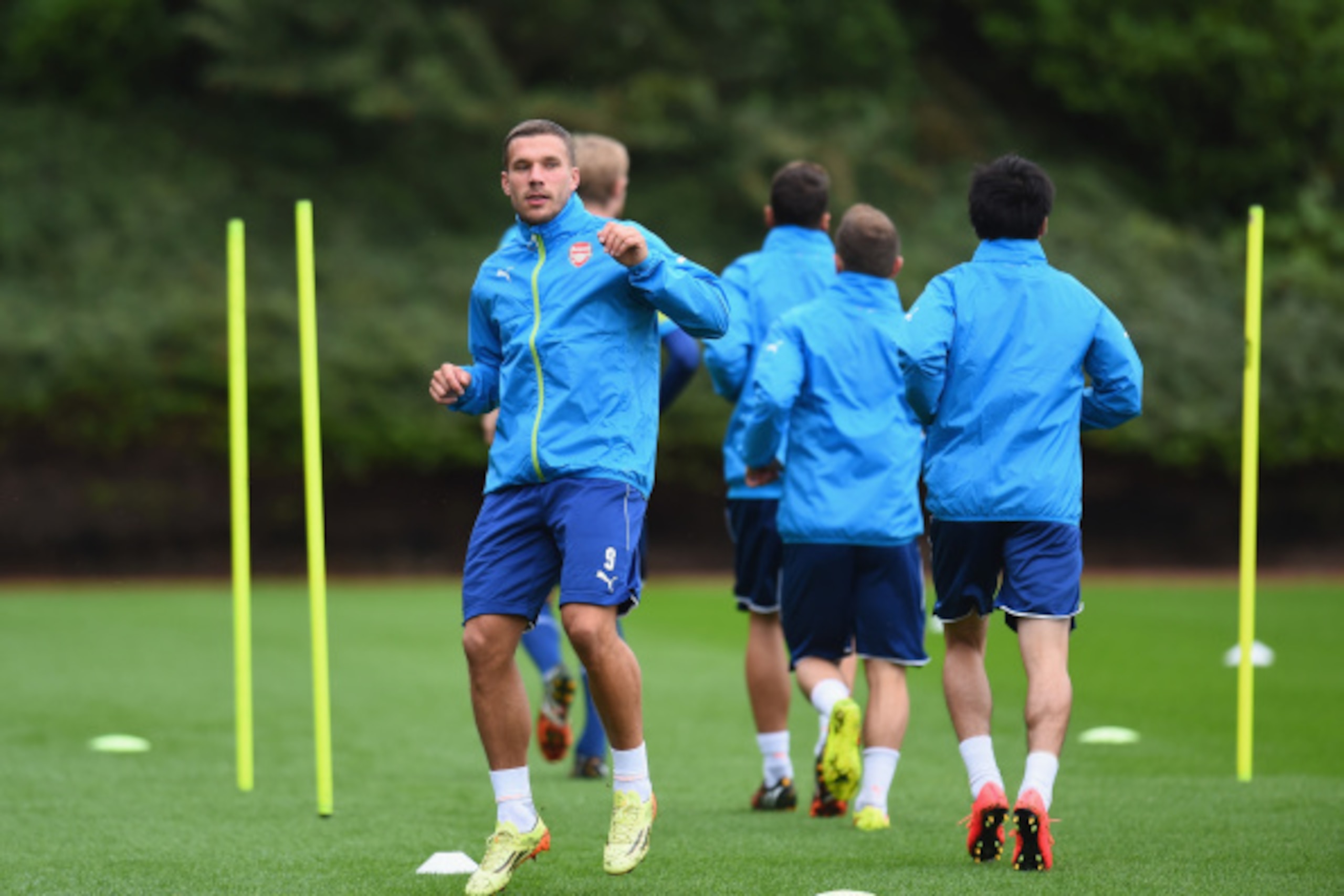 ST ALBANS, ENGLAND - AUGUST 26:  Lukas Podolski of Arsenal warms-up during a training session at London Colney on August 26, 2014 in St Albans, England.  (Photo by Shaun Botterill/Getty Images)