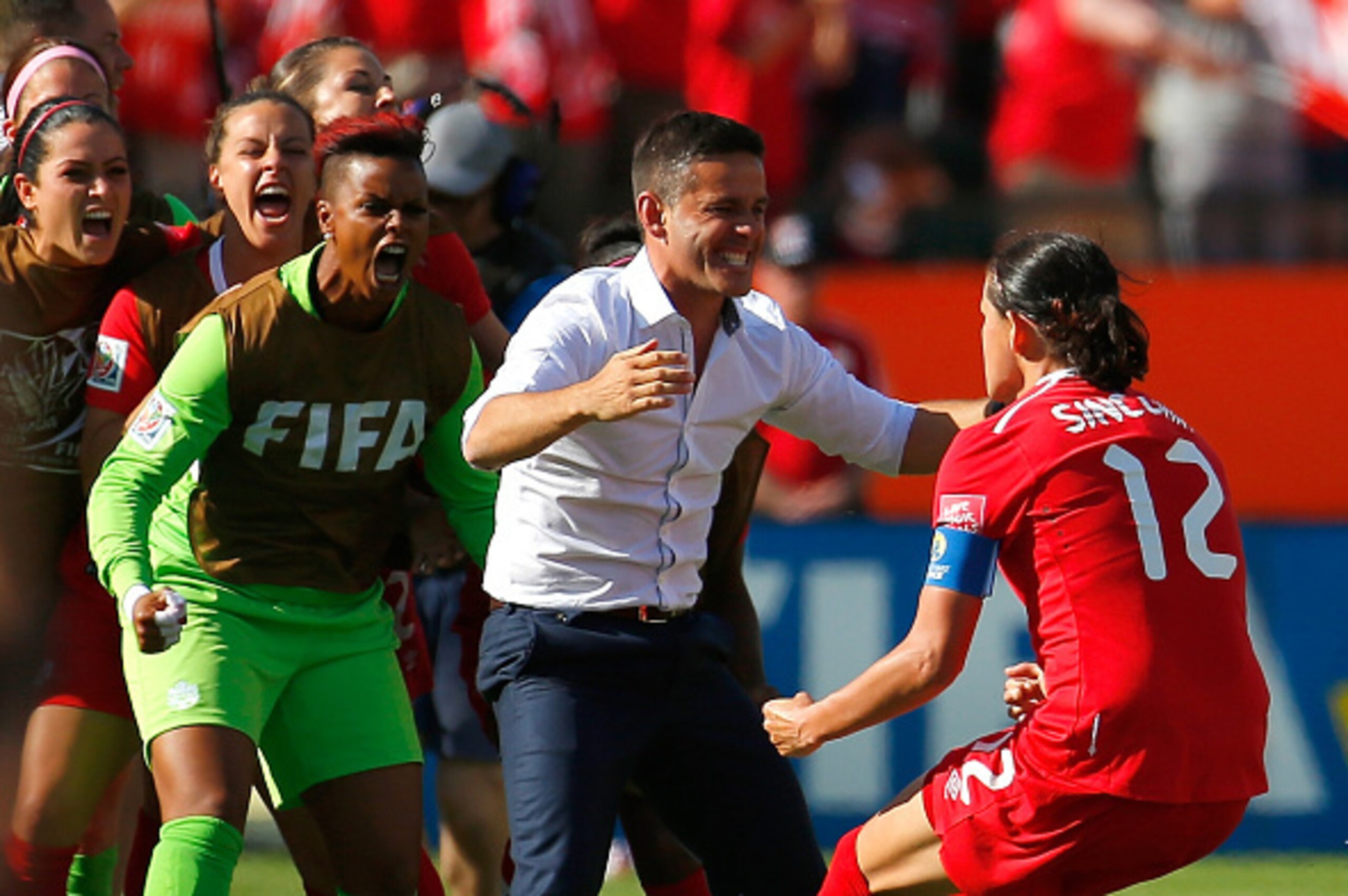 EDMONTON, AB - JUNE 06:  Christine Sinclair #12 of Canada celebrates scoring the go-ahead goal on a penalty kick against China PR with John Herdman during the FIFA Women's World Cup Canada 2015 Group A match between Canada and China PR at Commonwealth Sta