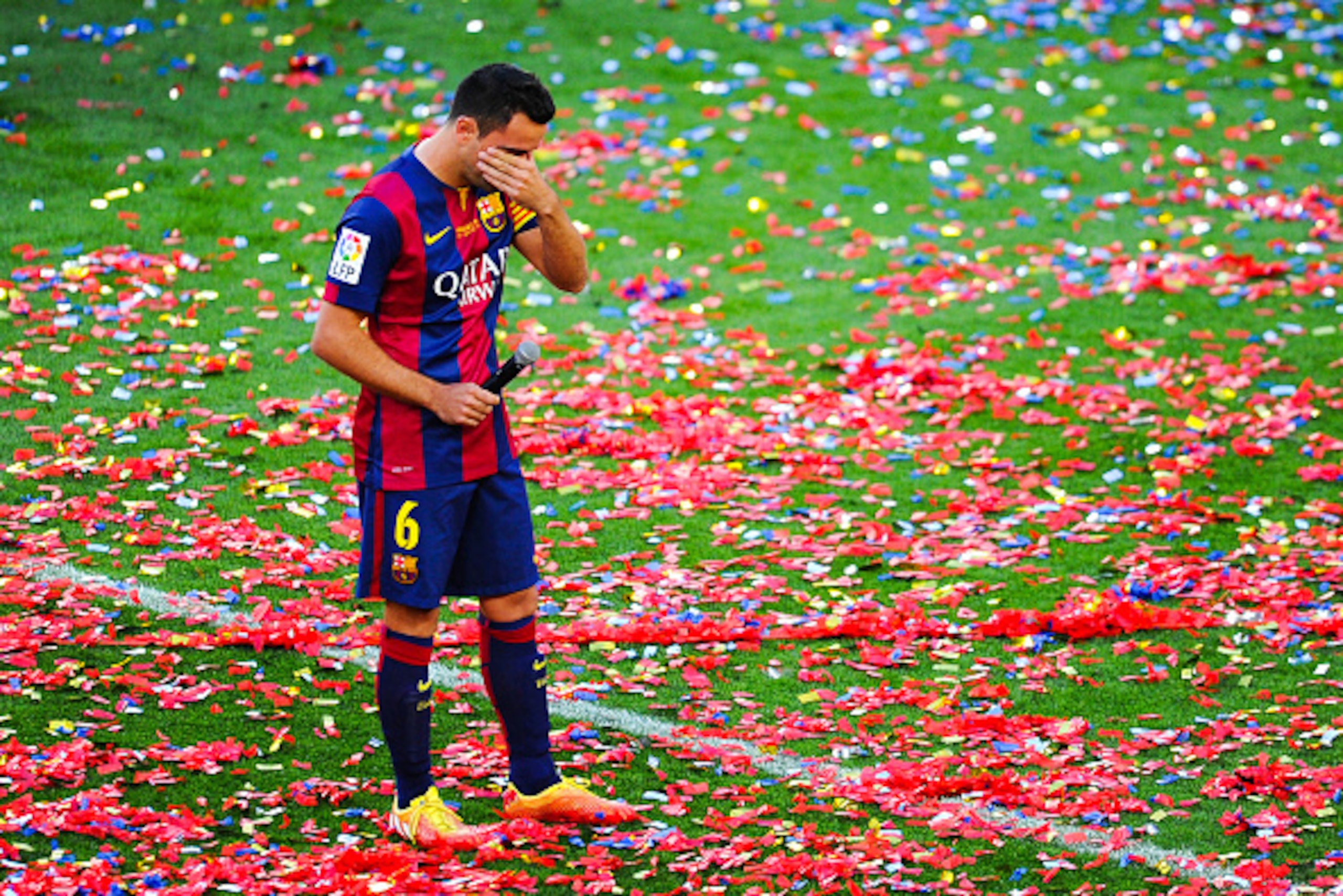 BARCELONA, SPAIN - MAY 23:  Xavi Hernandez of FC Barcelona wipes his tears at the end of the La Liga match between FC Barcelona and RC Deportivo de la Coruna at Camp Nou on May 23, 2015 in Barcelona, Spain.  (Photo by David Ramos/Getty Images)