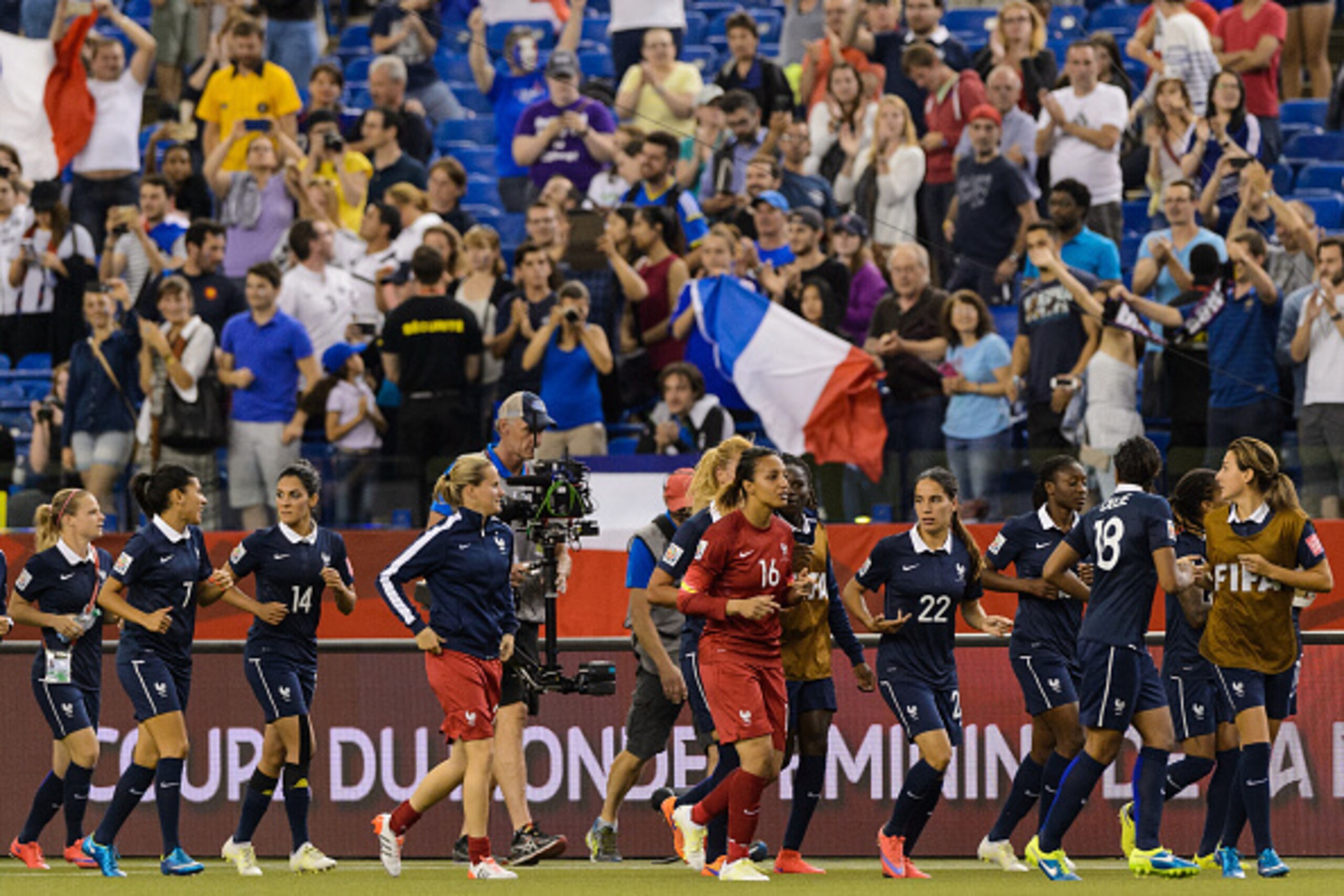 MONTREAL, QC - JUNE 21: Members of team France do a victory lap around the field during the 2015 FIFA Women's World Cup Round of 16 match against Korea Republic at Olympic Stadium on June 21, 2015 in Montreal, Quebec, Canada. France defeated Korea Republi MONTREAL, QC - JUNE 21: Members of team France do a victory lap around the field during the 2015 FIFA Women's World Cup Round of 16 match against Korea Republic at Olympic Stadium on June 21, 2015 in Montreal, Quebec, Canada. France defeated Korea Republi