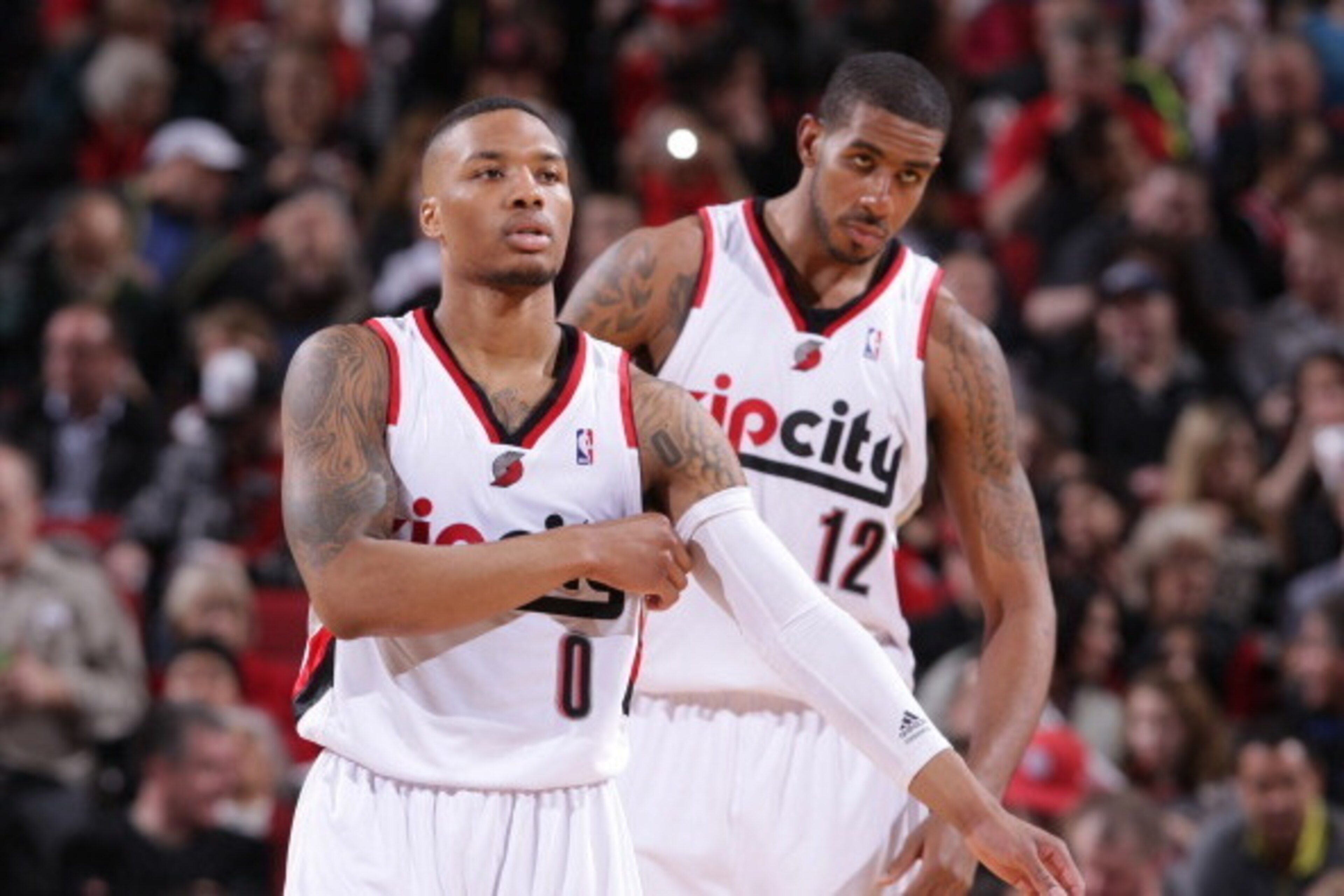 PORTLAND, OR - MARCH 5:  Damian Lillard #0 and LaMarcus Aldridge #12 of the Portland Trail Blazers stand on the court against the Atlanta Hawks on March 5, 2014 at the Moda Center Arena in Portland, Oregon. NOTE TO USER: User expressly acknowledges and ag
