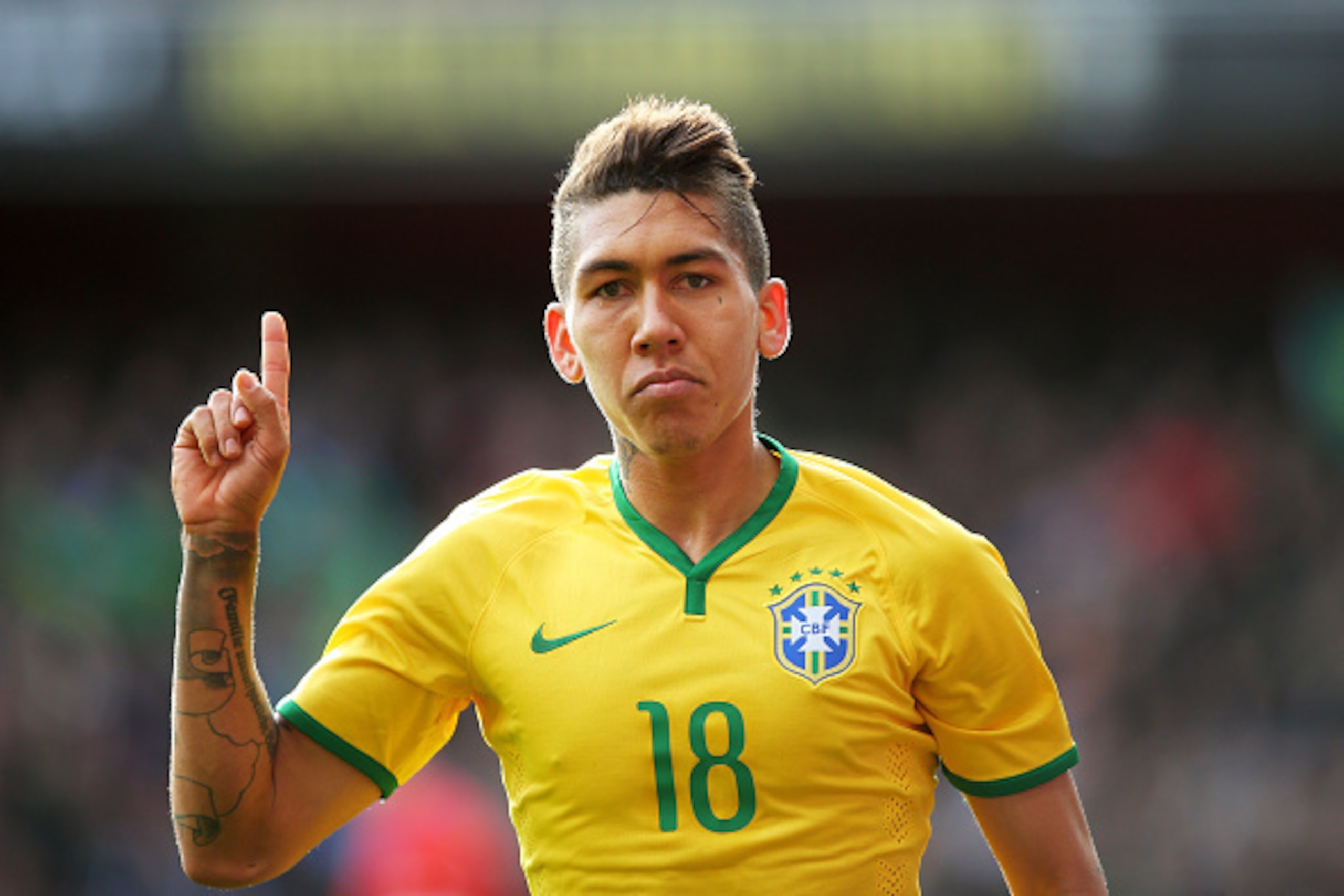 LONDON, ENGLAND - MARCH 29:  Firmino of Brazil celebrates after scoring the opening goal during the international friendly match between Brazil and Chile at the Emirates Stadium on March 29, 2015 in London, England.  (Photo by Paul Gilham/Getty Images)