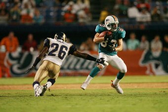 MIAMI - AUGUST 31:  Wide receiver Wes Welker #83 of the Miami Dolphins runs the ball while being pressured by Tye Hill #26 of the St. Louis Rams during the NFL game at Dolphin Stadium on August 31, 2006 in Miami, Florida. The Dolphins defeated the Rams 29