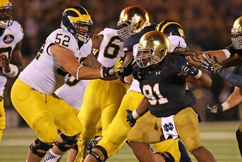 SOUTH BEND, IN - SEPTEMBER 06:  Sheldon Day #91 of the Notre Dame Fighting Irish rushes against Mason Cole #52 of the Michigan Wolverines at Notre Dame Stadium on September 6, 2014 in South Bend, Indiana. Notre Dame defeated Michigan 31-0.  (Photo by Jona