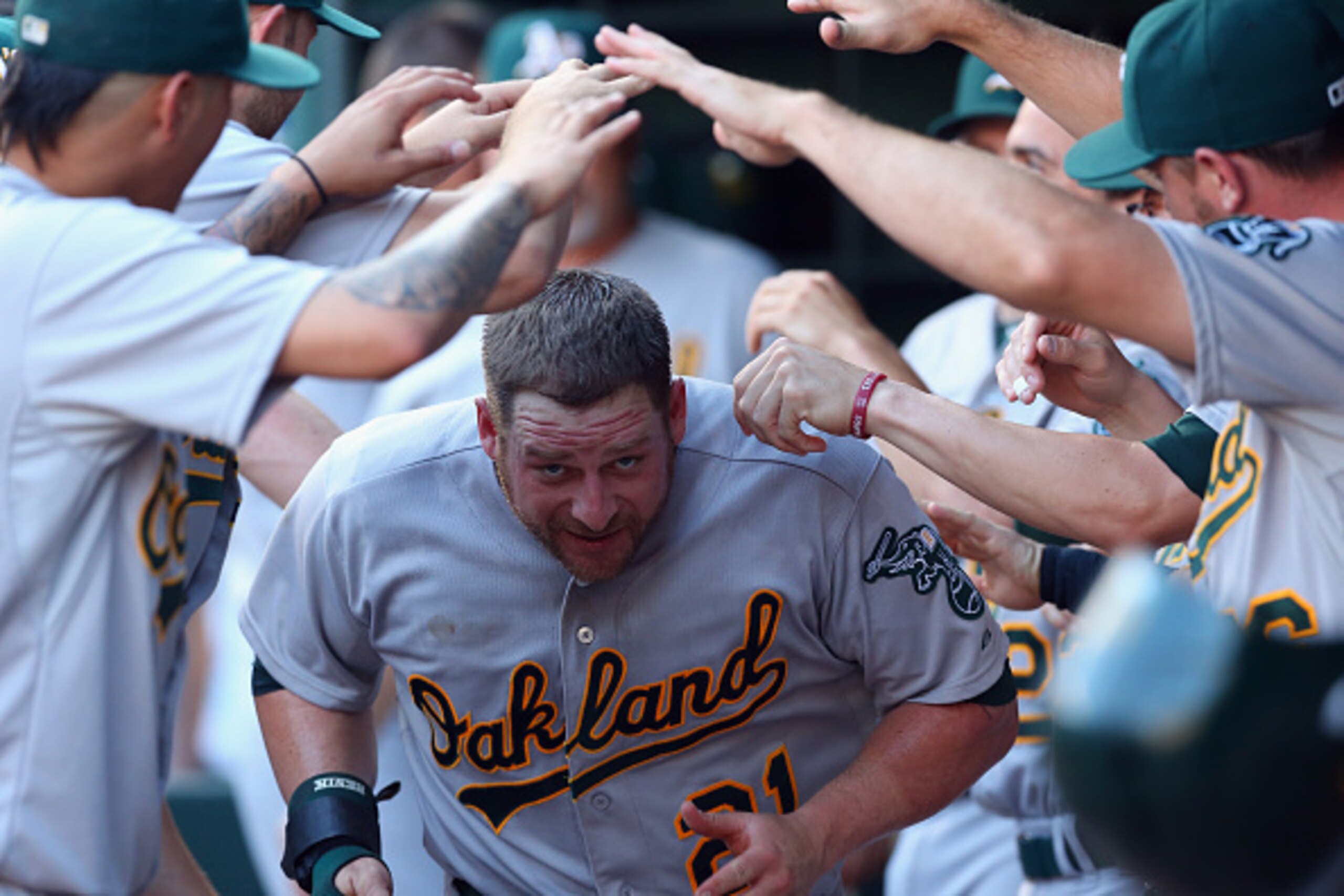ARLINGTON, TX - JUNE 24:  Stephen Vogt #21 of the Oakland Athletics celebrates after scoring against the Texas Rangers in the second inning at Globe Life Park in Arlington on June 24, 2015 in Arlington, Texas.  (Photo by Ronald Martinez/Getty Images)