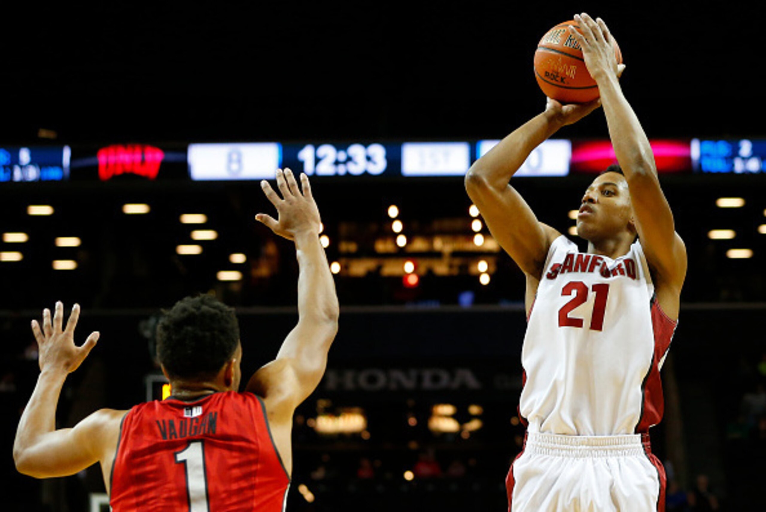 NEW YORK, NY - NOVEMBER 21: Anthony Brown #21 of the Stanford Cardinal takes a shot as Rashad Vaughn #1 the UNLV Rebels defends during the first half of a game in the Coaches vs Cancer Classic men's basketball tournament at Barclays Center on November 21,