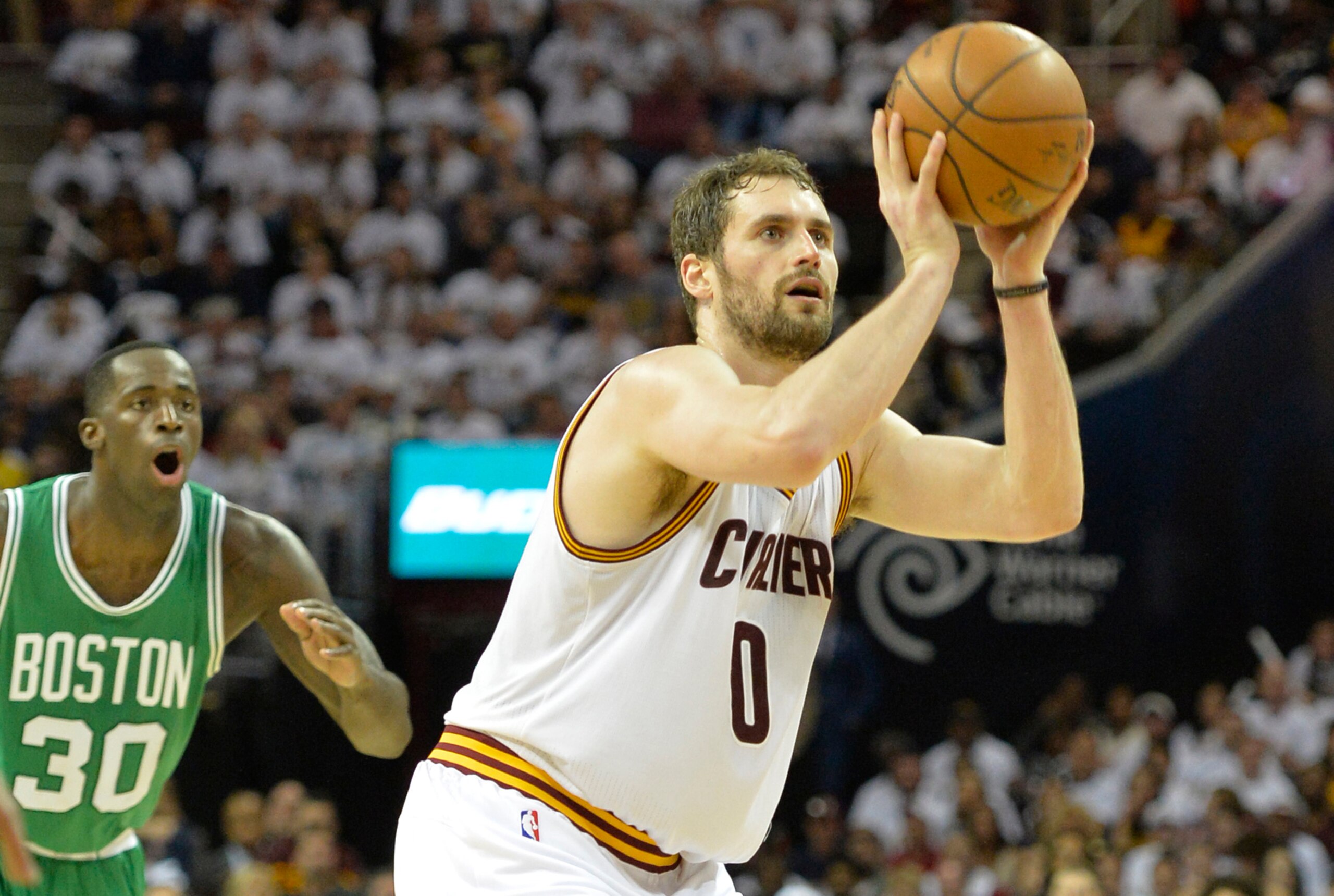 Apr 19, 2015; Cleveland, OH, USA; Cleveland Cavaliers forward Kevin Love (0) shoots beside Boston Celtics forward Brandon Bass (30) in the second quarter in game one of the first round of the NBA Playoffs at Quicken Loans Arena. Mandatory Credit: David Ri