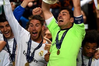 LISBON, PORTUGAL - MAY 24:  Iker Casillas of Real Madrid lifts the Champions League trophy as Sergio Ramos of Real Madrid (L) celebrates during the UEFA Champions League Final between Real Madrid and Atletico de Madrid at Estadio da Luz on May 24, 2014 in