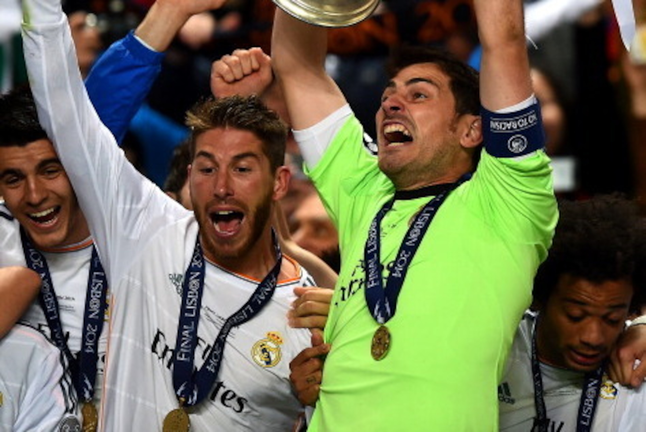 LISBON, PORTUGAL - MAY 24:  Iker Casillas of Real Madrid lifts the Champions League trophy as Sergio Ramos of Real Madrid (L) celebrates during the UEFA Champions League Final between Real Madrid and Atletico de Madrid at Estadio da Luz on May 24, 2014 in