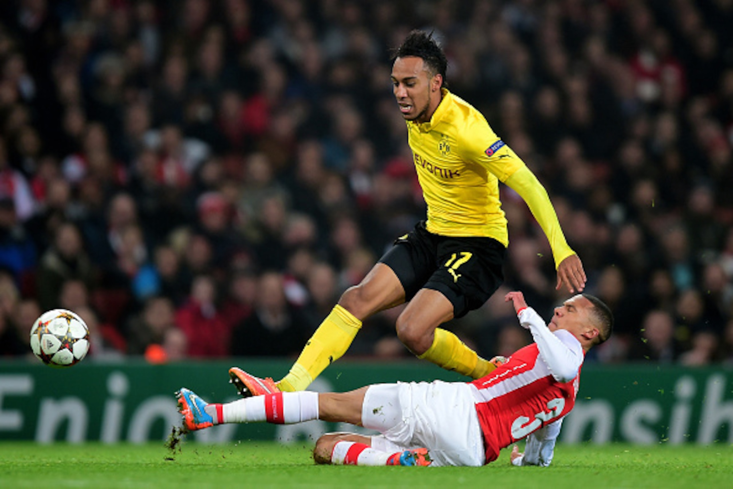 LONDON, ENGLAND - NOVEMBER 26:  Pierre-Emerick Aubameyang of Borussia Dortmund is tackled by Kieran Gibbs of Arsenal during the UEFA Champions League Group D match between Arsenal and Borussia Dortmund at the Emirates Stadium on November 26, 2014 in Londo